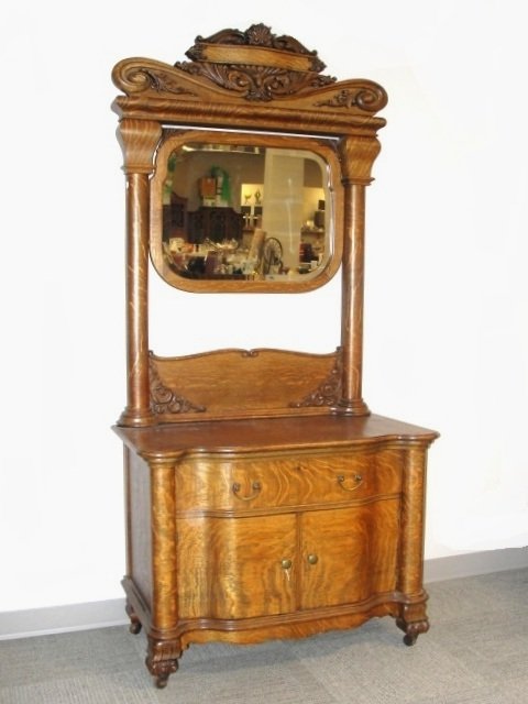 Carved 1/4 Sawn Oak Claw Foot Washstand: Having carved frame beveled glass mirror, large claw feet and shaped front. Condition older refinish, veneer repair on top with 5 '' checking in veneer on top. Very nice stylish Hotel style Ca. 1900's