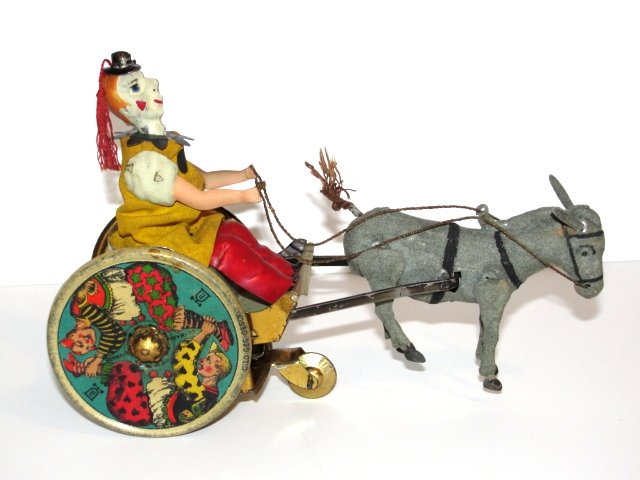 Lehmann Balky Mule Tin Litho Windup Toy: Germany, lithographed tin, large colorful wheels, great graphics, seated clown wears cloth outfit, clockwork driven, 8"l.