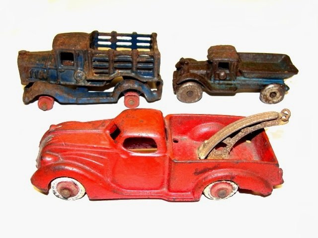 Cast Iron Toy Tow Truck With Tow Other Trucks: Condition tow truck no break, light wear to paint, tires hard and cracking 1 1/2''x 5 1/4'', small dump truck 50 % paint loss, light rust, no cracks 1 1/2'' x 3'', with two piece truck body parts with