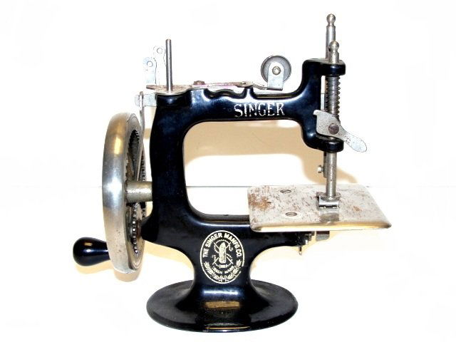 Singer Childs Toy Cast Iron Sewing Machine: Original, old Singer No. 20 child's nickel plated 8 spoke hand crank sewing machine from the 1920’s. Chrome and nickel plate with black enamel paint. Original markings. Condition very good minimal w