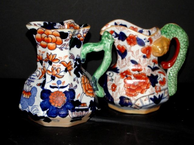 Early Mason Ironstone Polychrome Cream Jugs: Both stamped on base's, in oriental style polychrome paint designs. Condition both good. One having oriental face with snake body handle. Both 5 1/4'' tall