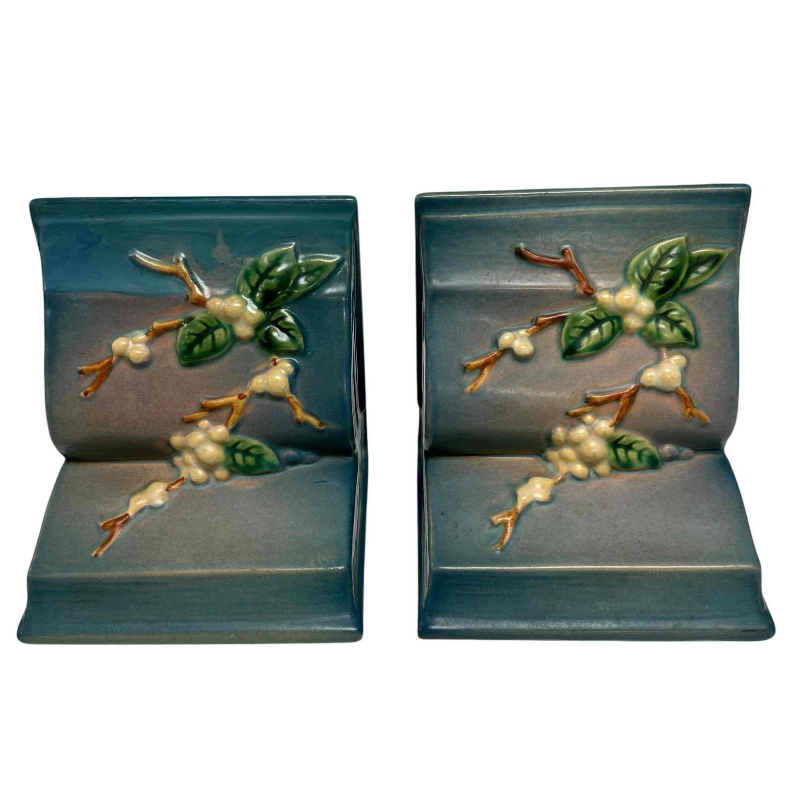 Pair of Roseville Pottery Snowberry Bookends: Pair of Roseville Pottery Snowberry bookends. They measure approximately 5 1/4" high x 5 1/4" wide. Marked on underside. Age appropriate condition - no chips or cracks. Top area appears to have had so