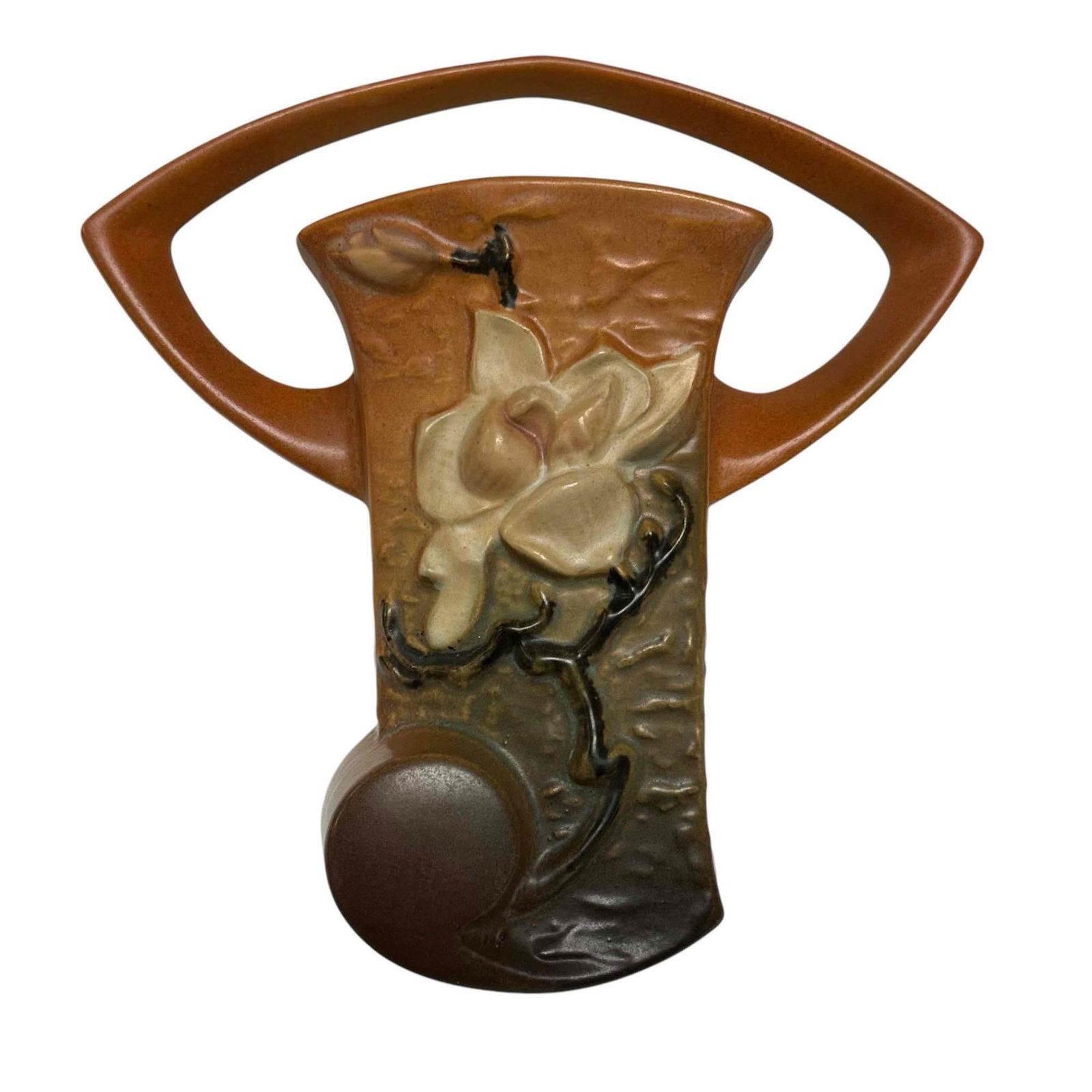 Roseville Pottery Magnolia Wall Pocket: Roseville Pottery Magnolia wall pocket in brown gradient with white flower. Marked Roseville U.S.A. 1294 on backside. Measures approximately 8 1/2" high x 8 1/4" wide. Age appropriate condition - no c