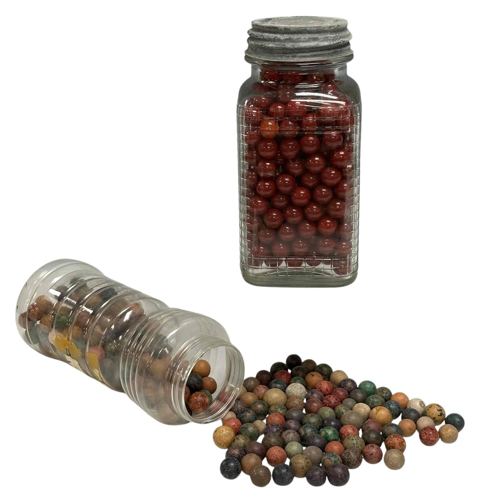 Group of Clay and Red Shooter Marbles: One jar filled with colored clay marbles and other is glass wine red later gaming marbles in antique zinc lidded glass jar as shown, see photos