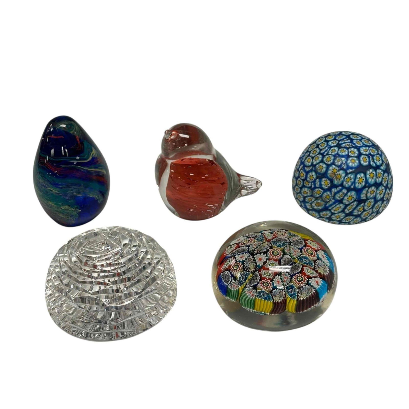 Five (5) Glass Paperweights: Five different paperweights. Included is one paperweight of a bird, a pressed crystal piece one oblong piece and a lighter, possibly hollow paperweight. Finally is an Italian paperweight with an excep