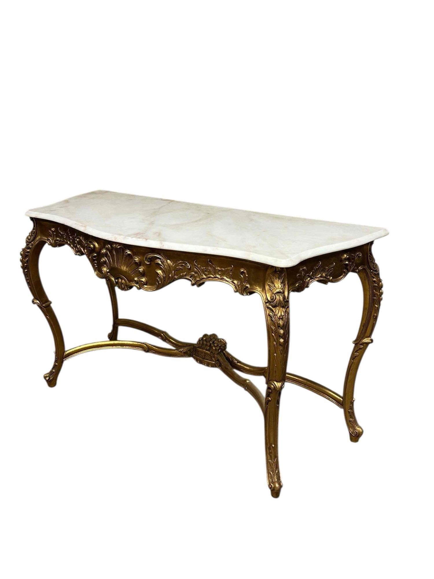 A Fine Italian Rococo Style Marble top Console Table: A fine a stately 19th century carved gilt wood console table with marble top. Measuring approx 36" h x 60" w x 23" d. Very good condition as shown, see photos