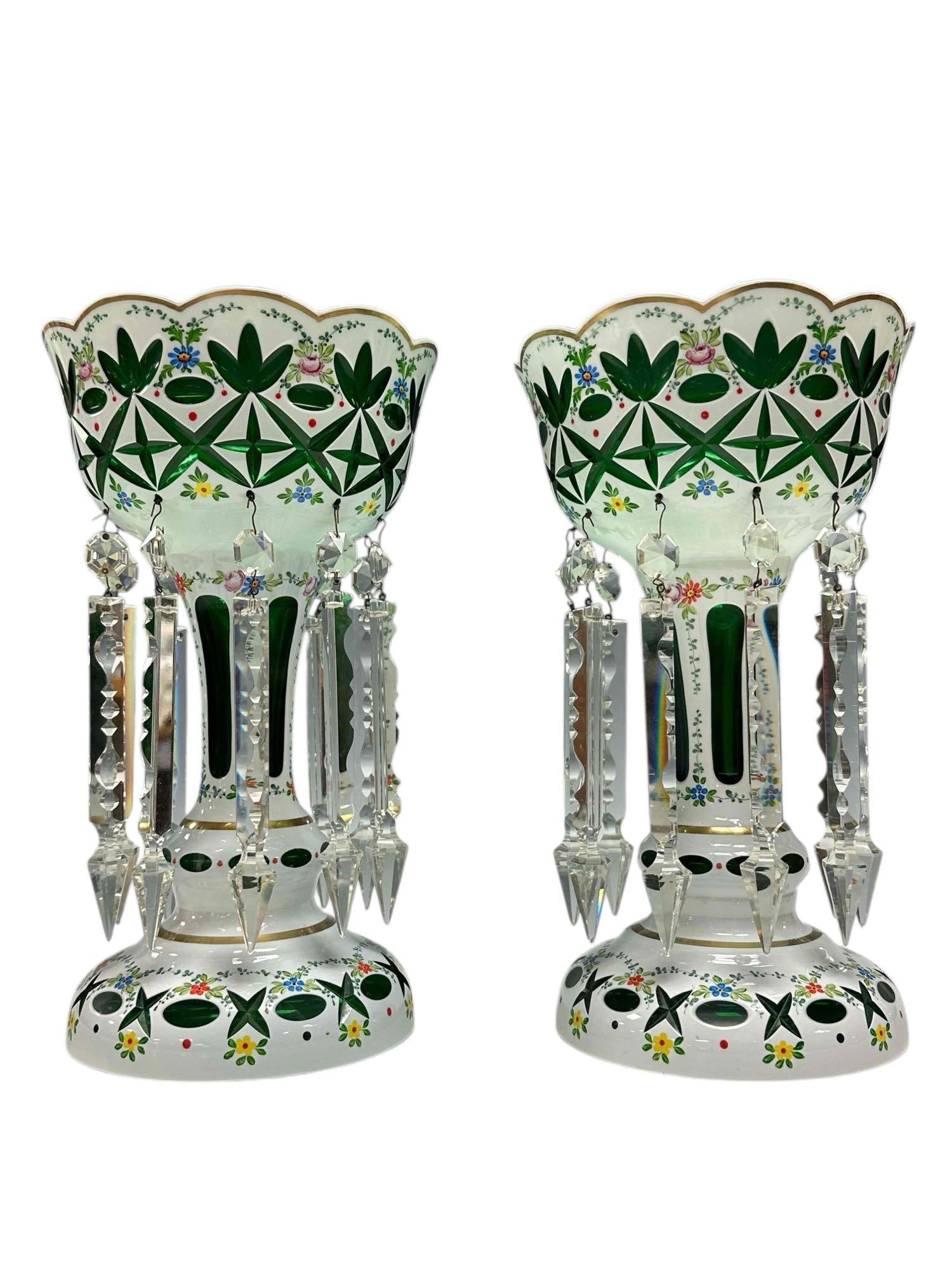 Bohemian Emerald Green Cut White Overlay Lustres: A fine pair of late 19th century Mantle Lusters with long drop sear prisms. Emerald green, white overlay and hand painted enamel accents throughout. measuring approx 12.5" h x 7.5" diameter. Good cond