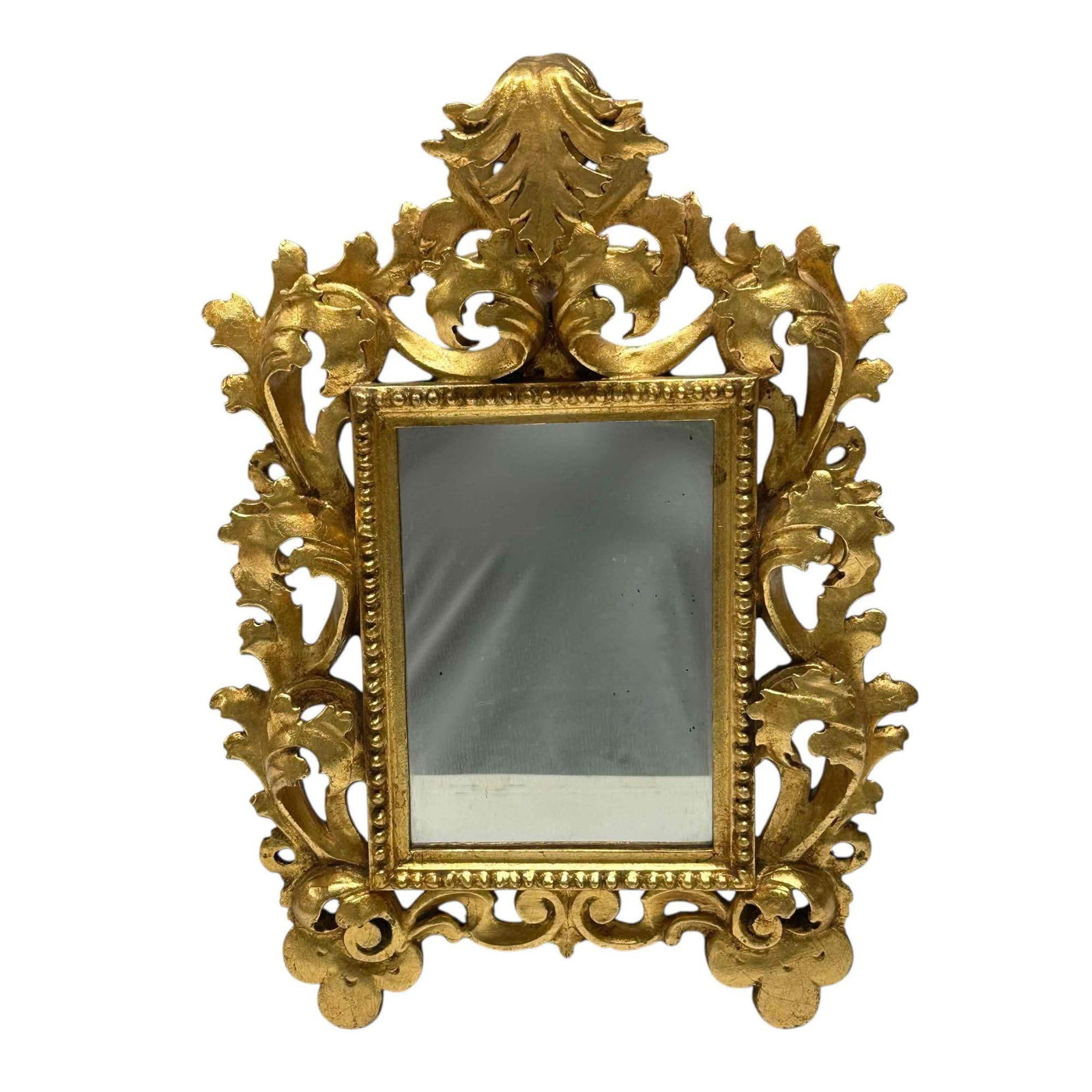 Italian - Gilt Wood Carved Rocco Mirror: Elegant and petite sized carved wood mirror with gilt. Measuring approx 15" h x 11" wide. Great decorator mirror. Good condition as shown, see photos