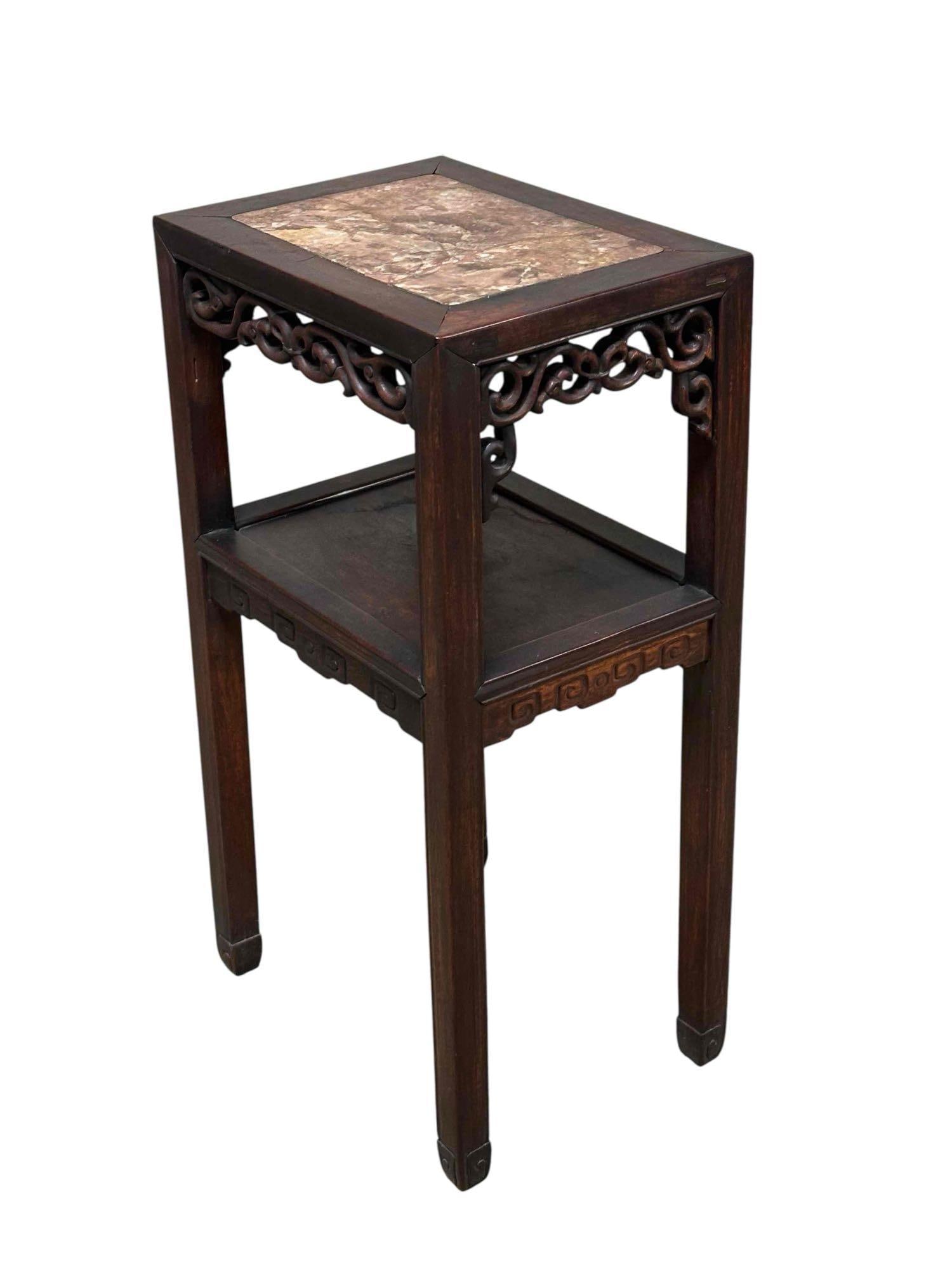 Carved Chinese Rosewood Marble Top Stand: Rectangular form with inset marble, lower tier shelf and applied carved skirt or apron. Late 19th c / early 20th. Measuring approx 32" h x 16.5" w x 12" d. Appears to have old repair to marble as show