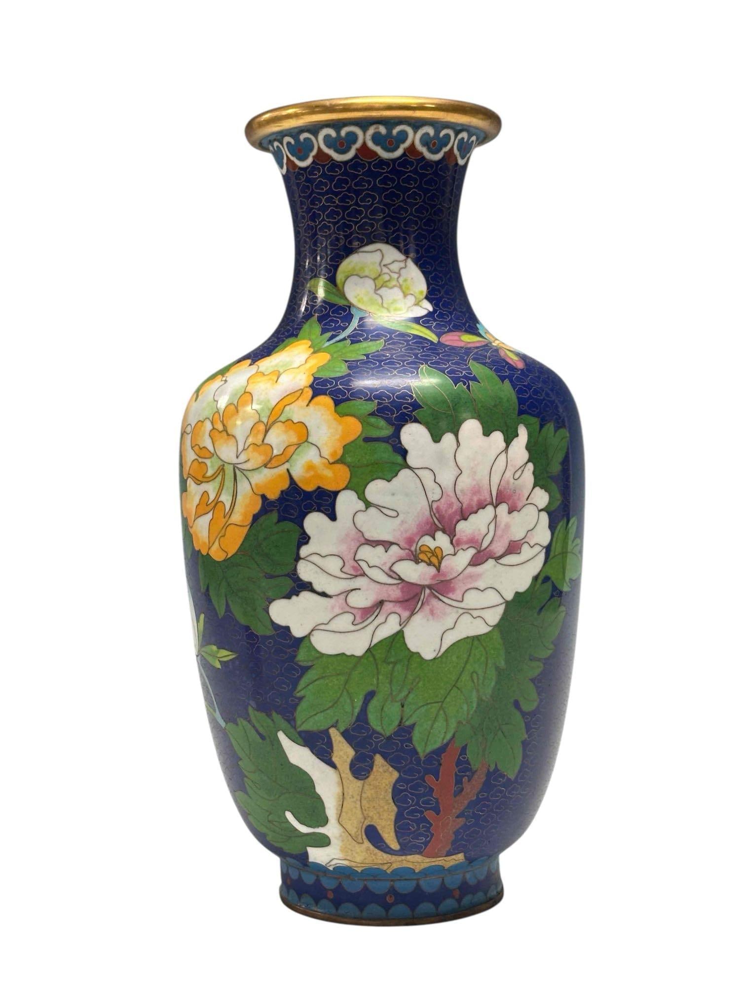 Chinese Cloisonne Butterflies and Floral Vase: Cloisonne vase decorated with bright butterflies and flowers over a blue backdrop/ Measuring approx. 12.25" tall. In good condition with no breaks or cracks, see photos.