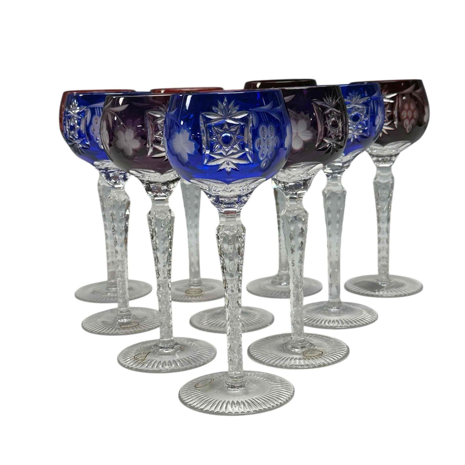 NACHTMANN Grape Wine Hock Colors Cut to Clear (10): Set of 10 NACHTMANN Grape Wine Hock Ruby, Purple and Blue Cut to Clear crystal stemware. Note; one dark red piece is a slightly different pattern. Measuring approx. 8.5" tall. In good condition, see p