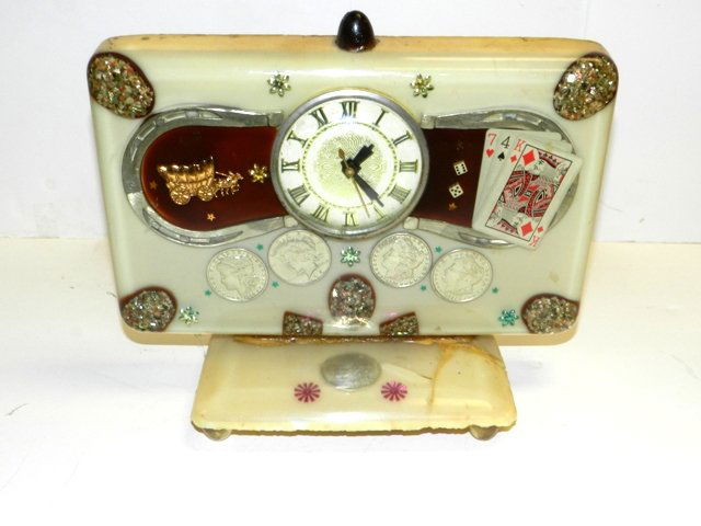 1950's Landshire Silver Dollar Gamblers Clock: Unique gamblers shelf clock with 5 silver coins imbedded in the heavy clear mold as shown. Crack and repair on base as shown. Currently working although no guarantees