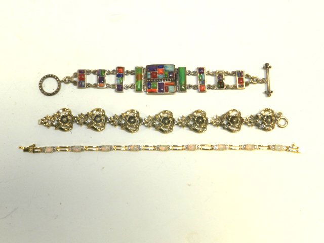 3 Ladies Vintage Sterling Bracelets: Including gold over sterling moonstone bracelet, rose raised relief bracelet with multi inlaid stone bracelet. Condition all with normal wear.