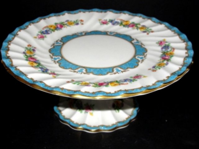 Crown Staffordshire Hand Painted Cake Stand: Having gold accents, floral decorations with bluish green borders. Condition very good. 3 1/2'' high 9'' diam.