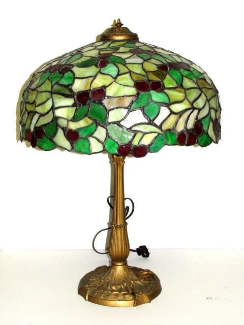 Chicago Mosaic Leaded Stained Glass Lamp: With floral and cherries design. As with most Chicago Mosaics, the glass is very fiery and glistens when lit. Vibrant red cherries and green leaves. Condition overall good,, small crack to piece of gl