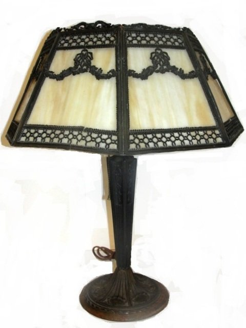 Slag Glass Panel Lamp- Metal Designed Frame: Having 6 Carmel color panels, and metal work of swaging flowers over each pane. Condition one section of swag missing new wiring wear to finish. 22'' tall