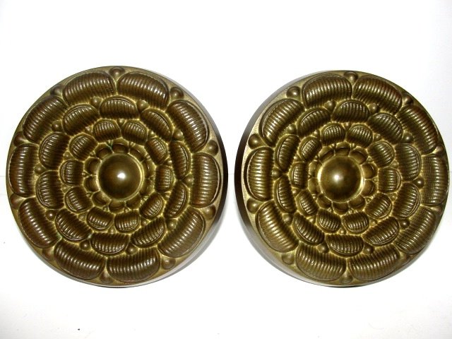 Pair Bronze Embossed Curtain Tie Backs 1900's: Nice pair of tie backs appearing to be a blooming flower in original nice bronze patina. Condition very good. 4 3/4'' dia. Total depth without screw 3 1/2''
