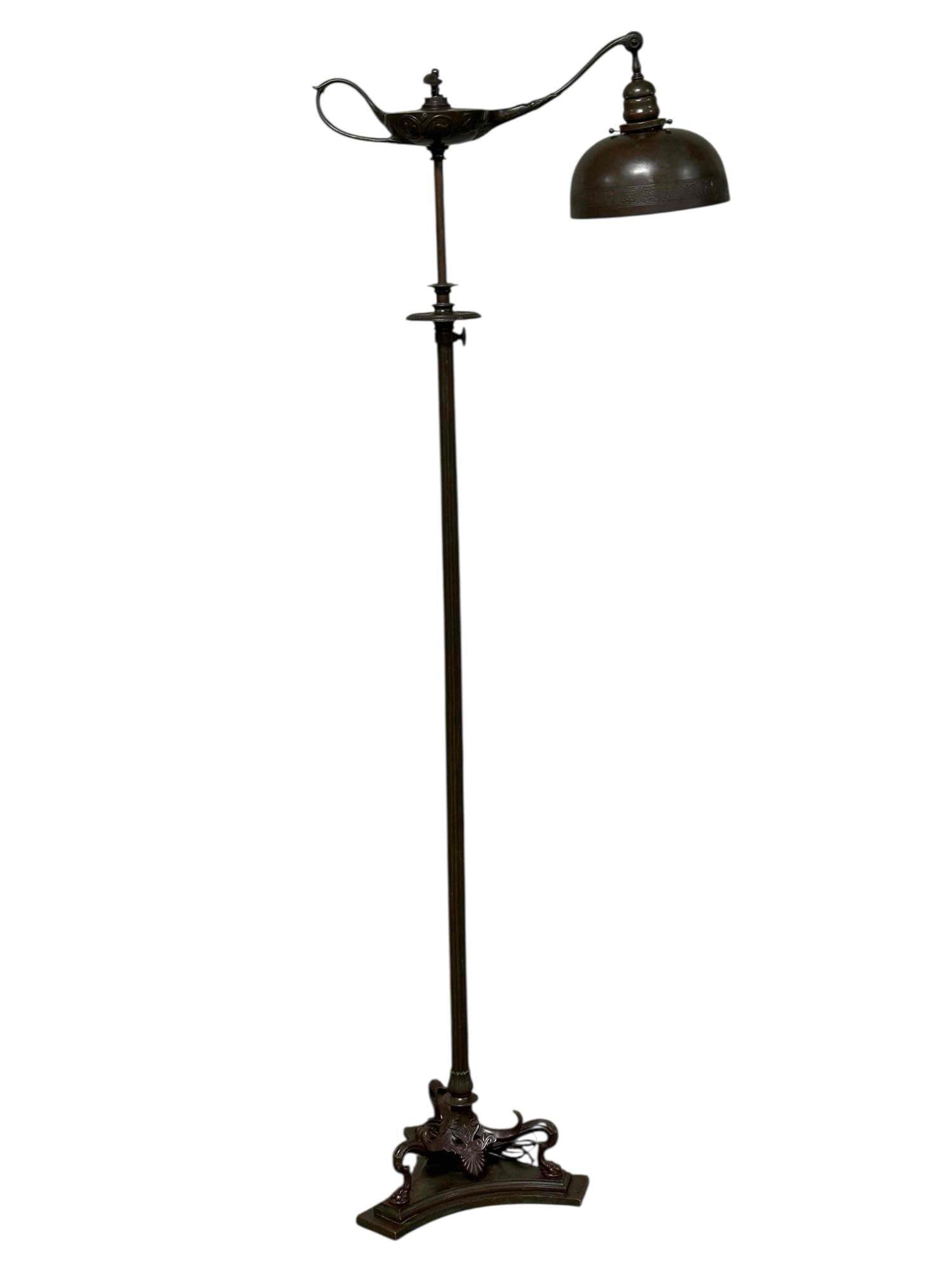 Tiffany Studios "Aladdin’s Lamp" Bronze Dore Floor Lamp: A fine and elaborate, Tiffany Studios NY bronze dore floor lamp, designed in the style of Aladdin’s lamp on a neoclassical greco Roman base, dating to circa 1910. Finial characterized with a cherub
