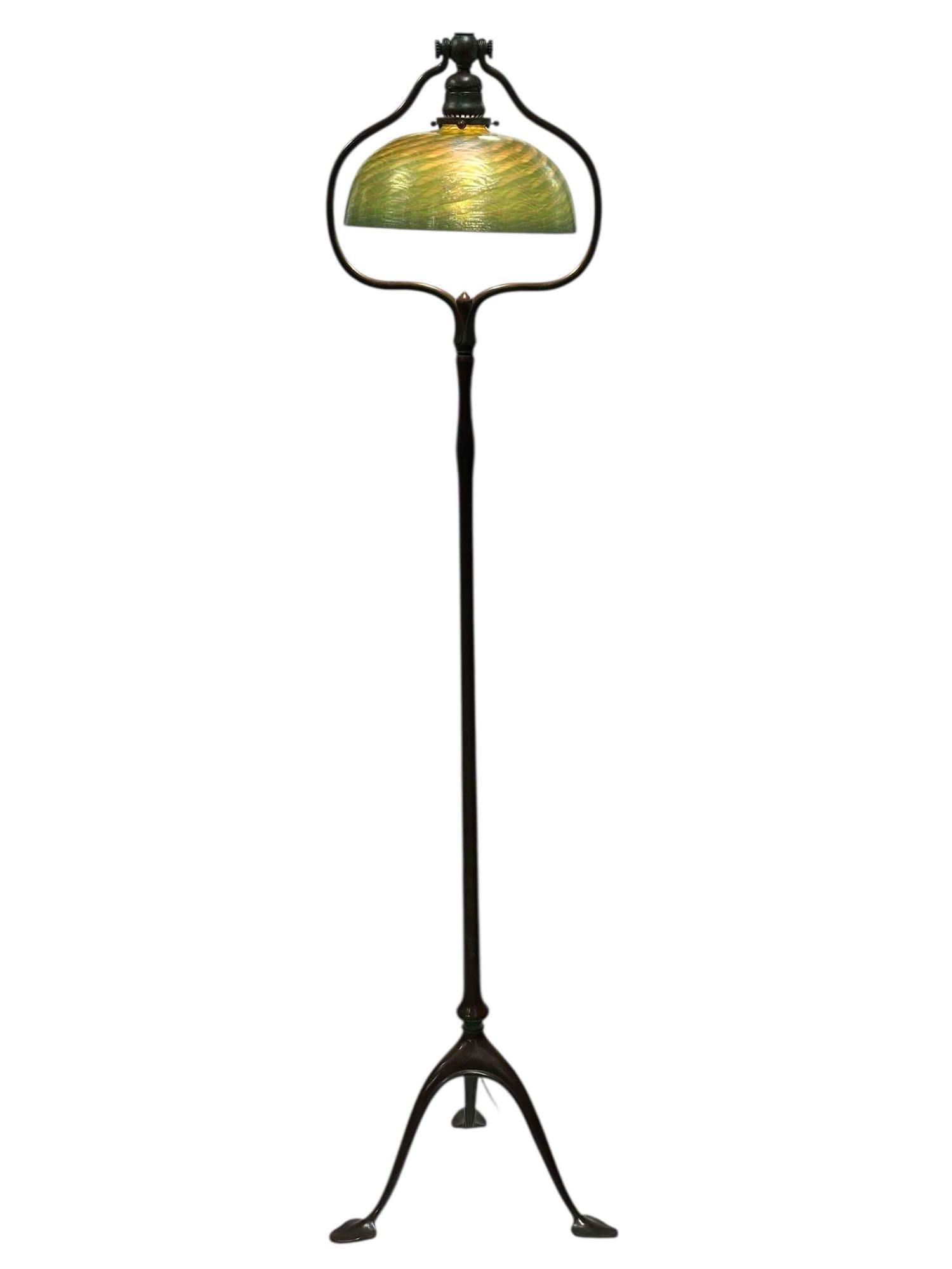 Tiffany Studios "Harp" Floor Lamp with Damascus Shade: A Tiffany Studios Bronze Harp Floor Lamp, Circa 1910, Model #423 tripod lily pad base, having signed Favrile glass shade engraved L.C.T. Favrile. The patinated bronze tripod lamp base signed and numbe