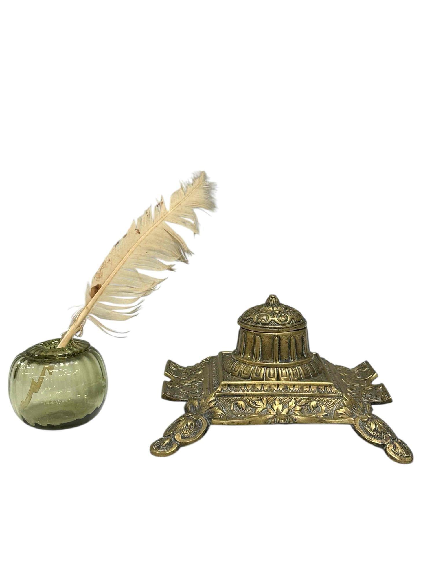 French Brass Inkwell with Glass Orb Inkwell: Large ornate footed brass inkwell with pen trays and gray glazed stoneware ink reservoir. Having raised relief scalloped floral and acanthus leaf designs. Measuring 7" by 7" at base by 4" tall. Accomp