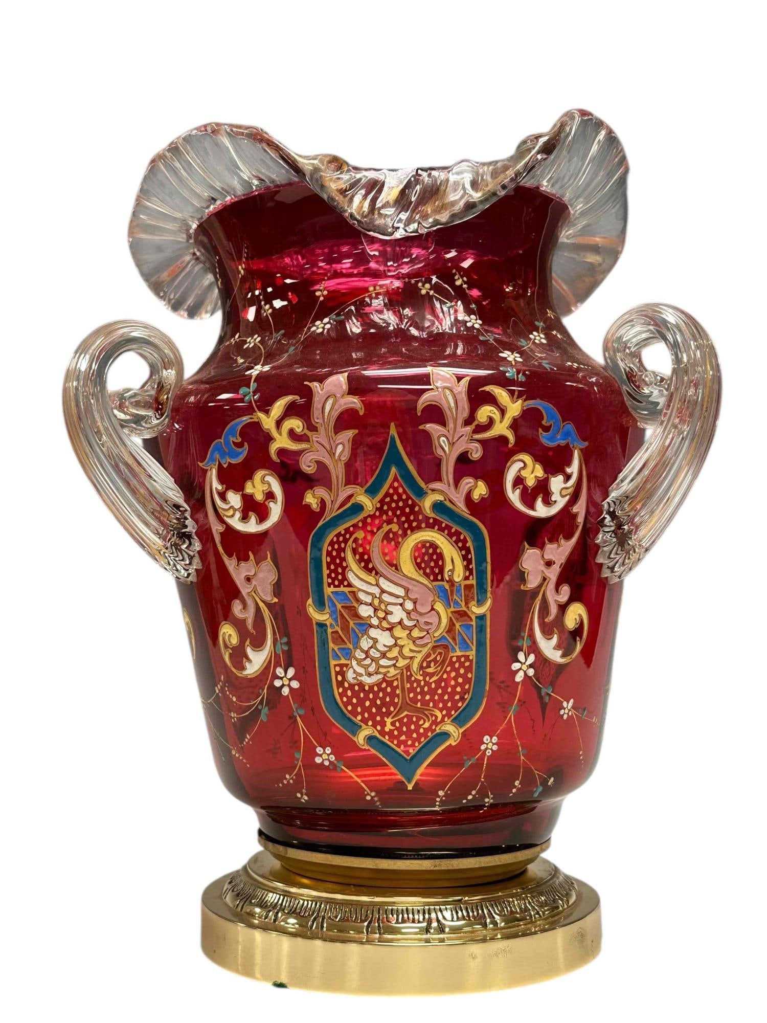 Bohemian Moser Cranberry Enameled Glass Vase 13": Large Bohemian Moser art glass cranberry ruffled top vase. Having hand painted enamel and gilt floral vine decoration with a center medallion crest of bird or swan posing on one leg. Three applied flu
