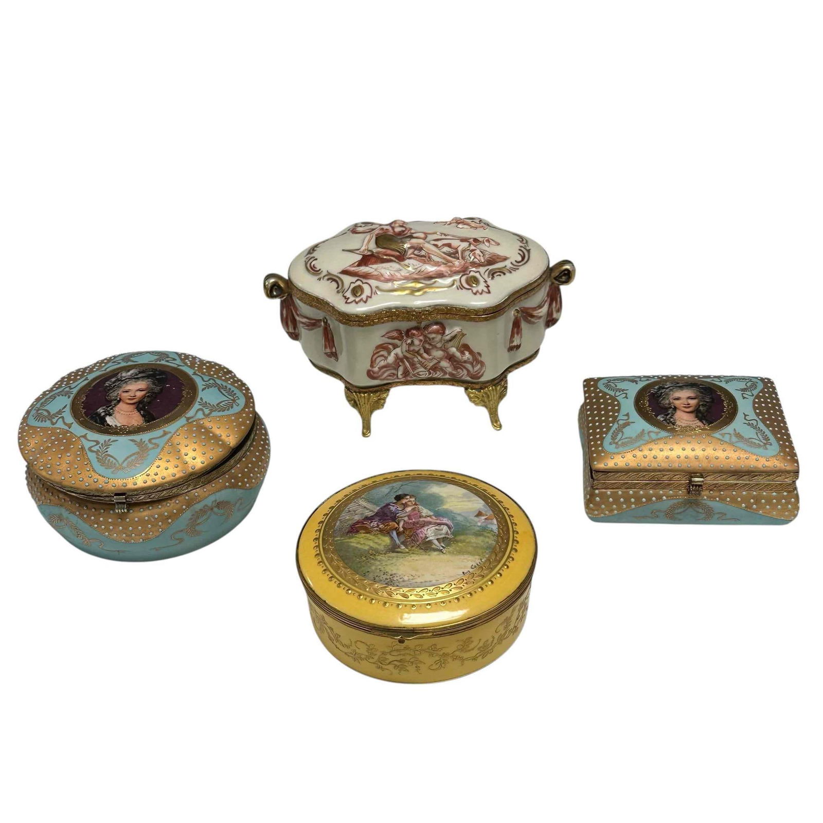French Porcelain Vanity Dresser Boxes (4): Includes; Capodimonte footed raised relief jewelry casket box depicting naked woman with dogs and cherubs on brass legs and frame 8" wide by 4.5" tall, artist signed yellow trinket box depicting young