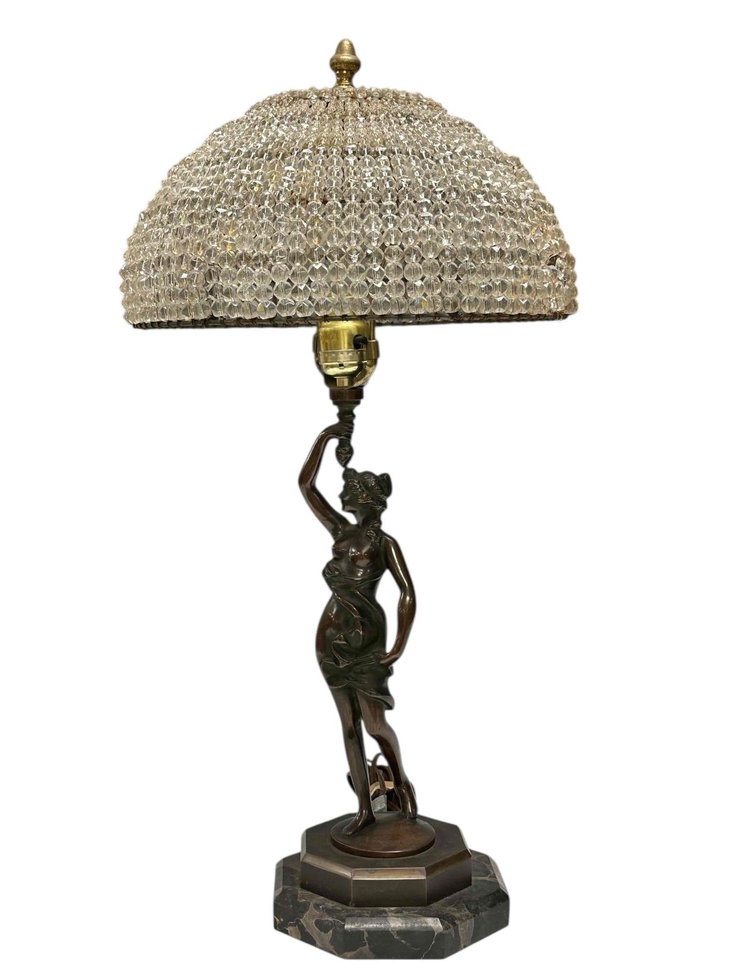 Bronze Art Nouveau Nude Goddess Figural Lamp Beaded Shade: Art nouveau bronze half nude goddess holding a torch figural lamp on octagonal marble base. Having wire beaded domed shade. Measuring approx. 24" tall. In good age appropriate condition, see photos.