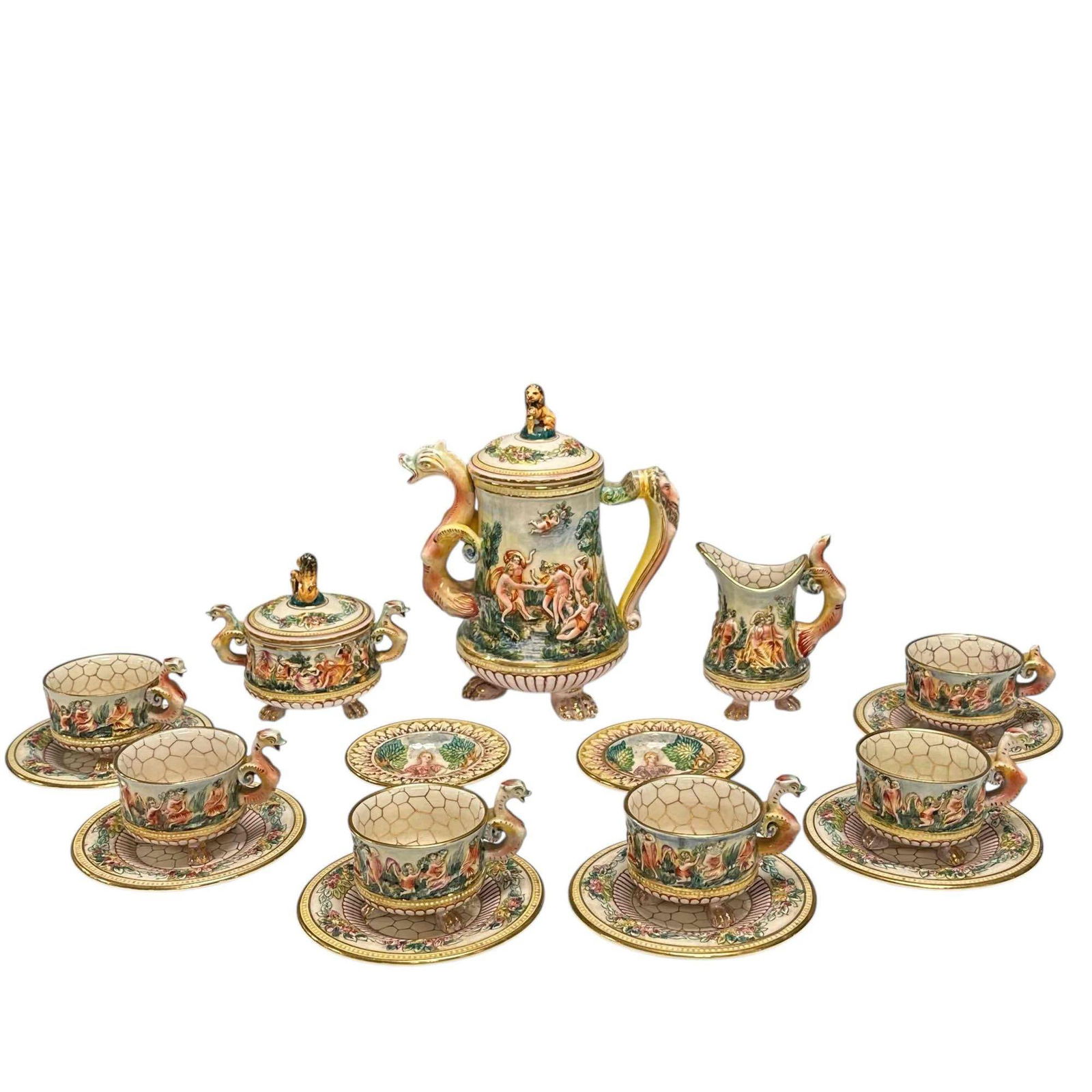 Capodimonte Dragons and Nude Lovers Tea Service for Six Set: Mid 20th century Capodimonte bold ceramic dragon handle tea service for six. Elaborate design depicting scenes of nude lovers and cherubs, paw footed, seated lion lid finials with breasted dragon hand