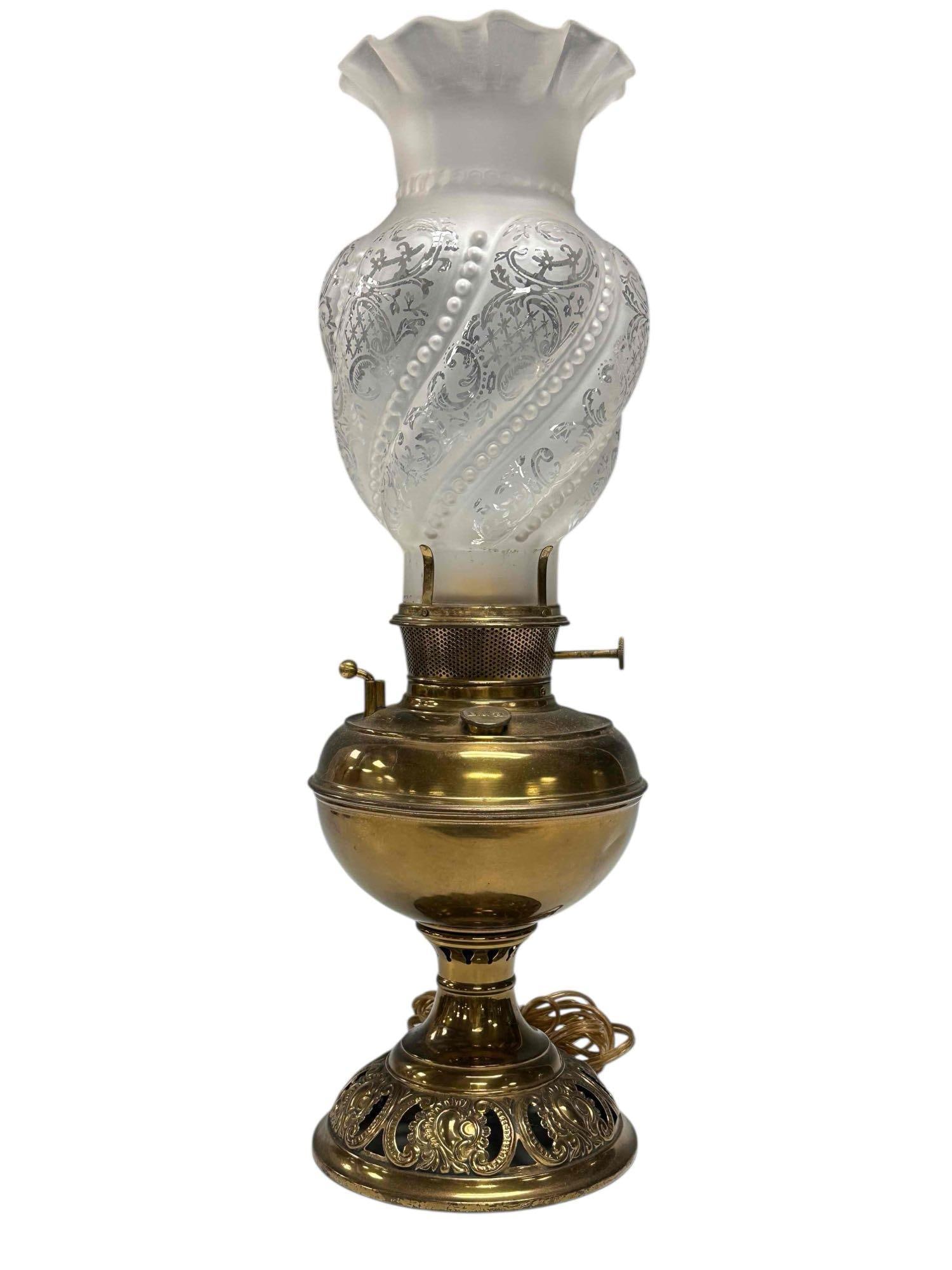 Bradley Hubbard Oil Lamp with Frosted Glass Shade: Bradley and Hubbard late 19th early 20th century electrified brass oil lamp with ruffled top frosted glass beaded drape design shade. Measuring approx. 18.75" tall to top of shade. Embossed B&H on