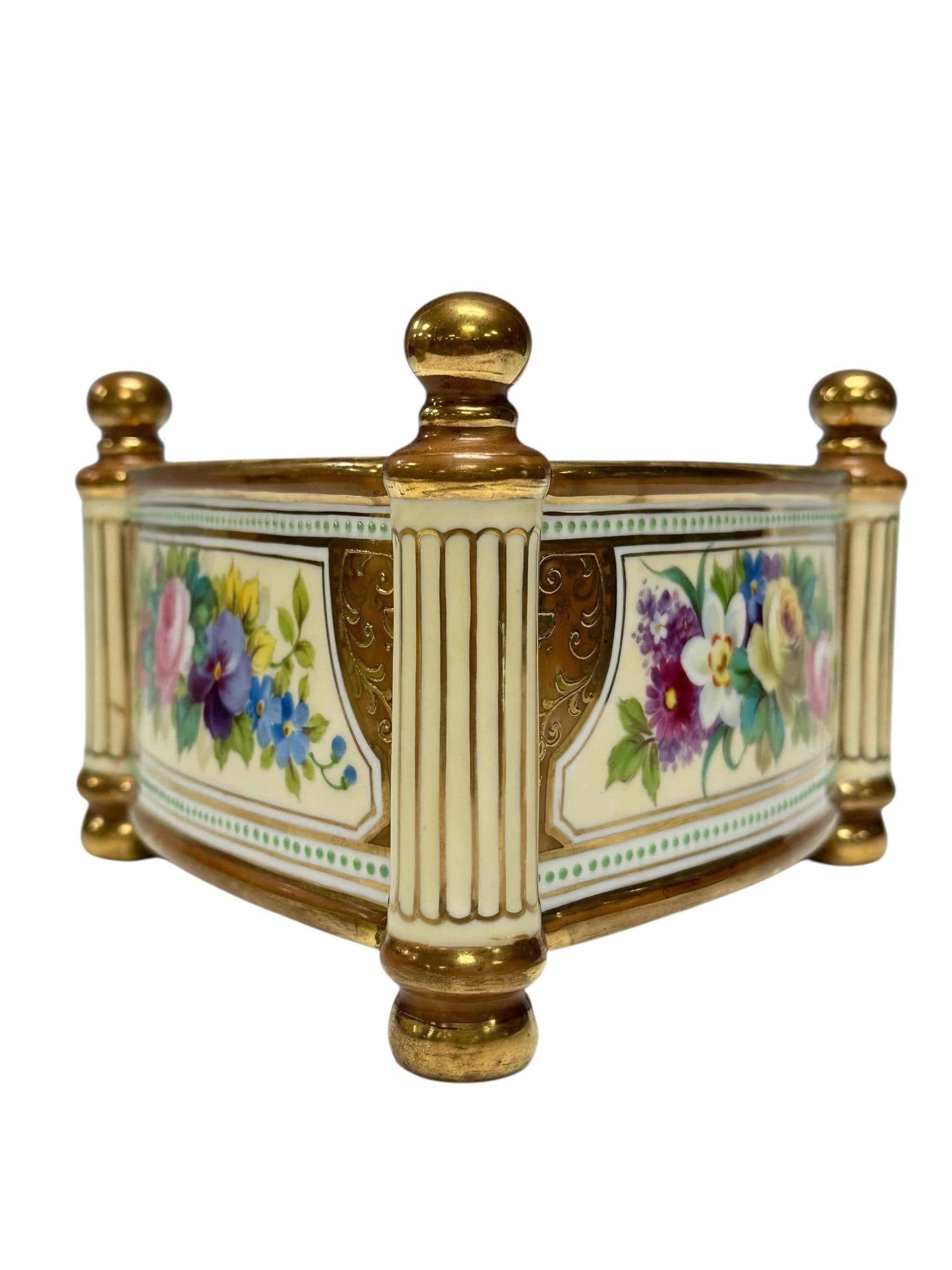 19th Century Nippon Bough Pot Triangular Planter Box: Nippon porcelain triangular raised footed cachepot in the neoclassic style with floral decor and flute column legs. Measuring approx. 4.75" tall by 8.25" wide. In good age appropriate condition, see p