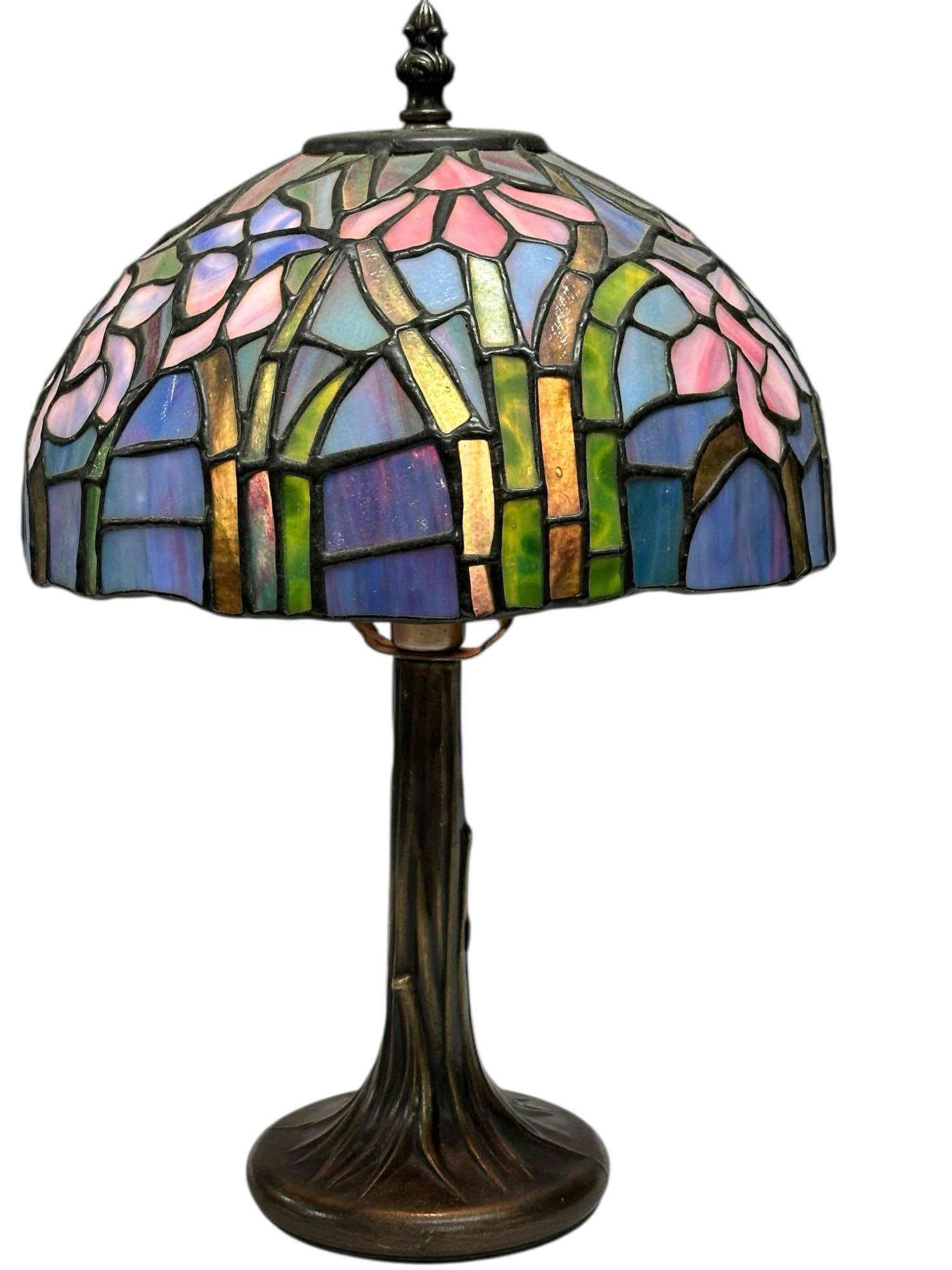 Art Nouveau Style Stained Glass Table Lamp: Art nouveau style with tree trunk style base with blue, green and white wisteria shade. Measuring approx.15.56" tall. In good condition, see photos.