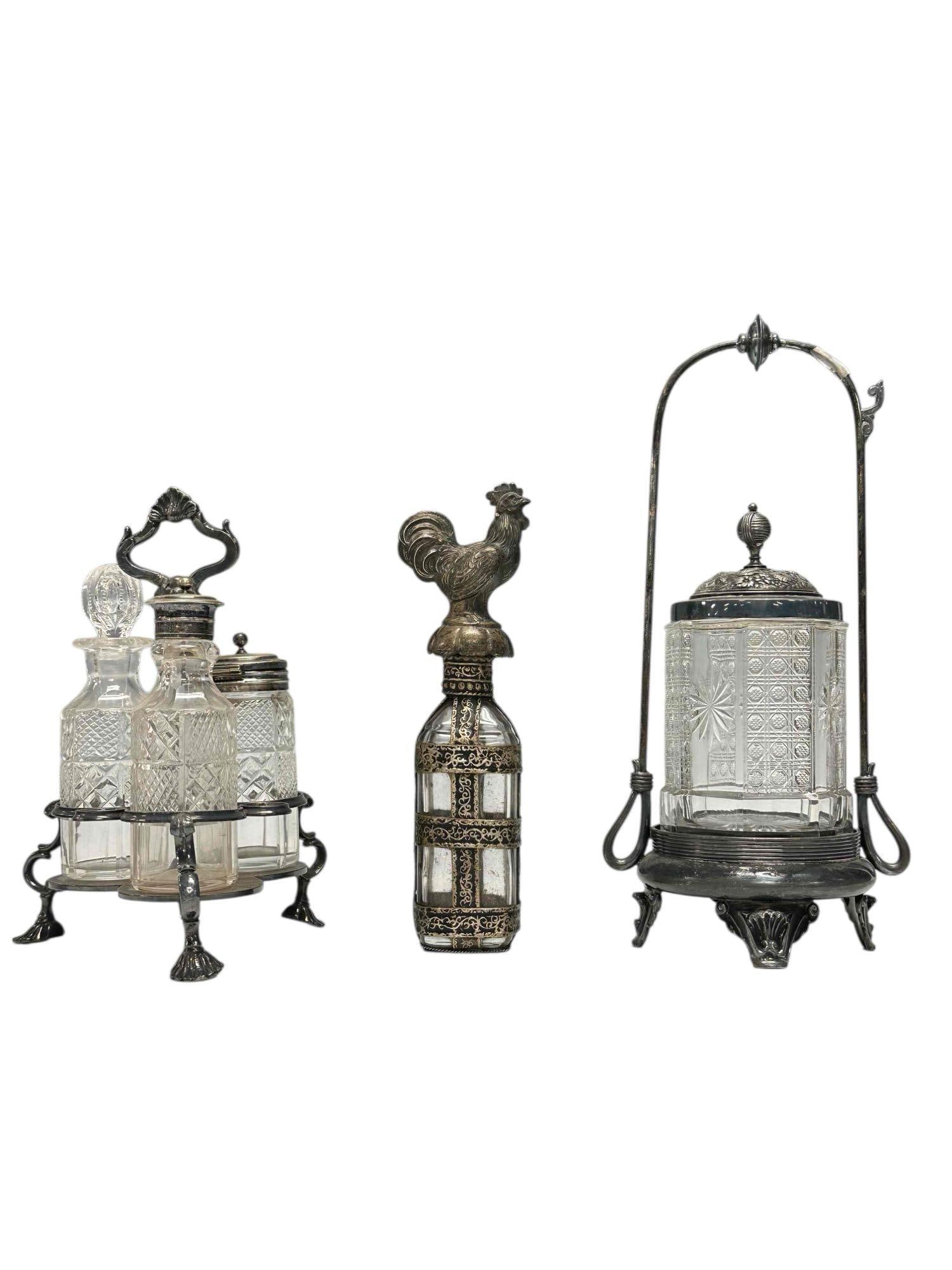 19th Century Cruet Set Pickle Caster and Rooster Decanter (3): Victorian era cut glass jars silver plated cruet set on scalloped feet 8.25" tall, ornate cut glass pickle castor with floral decor lid 11.25" tall and unusual metal overlay banded decanter or cruet w