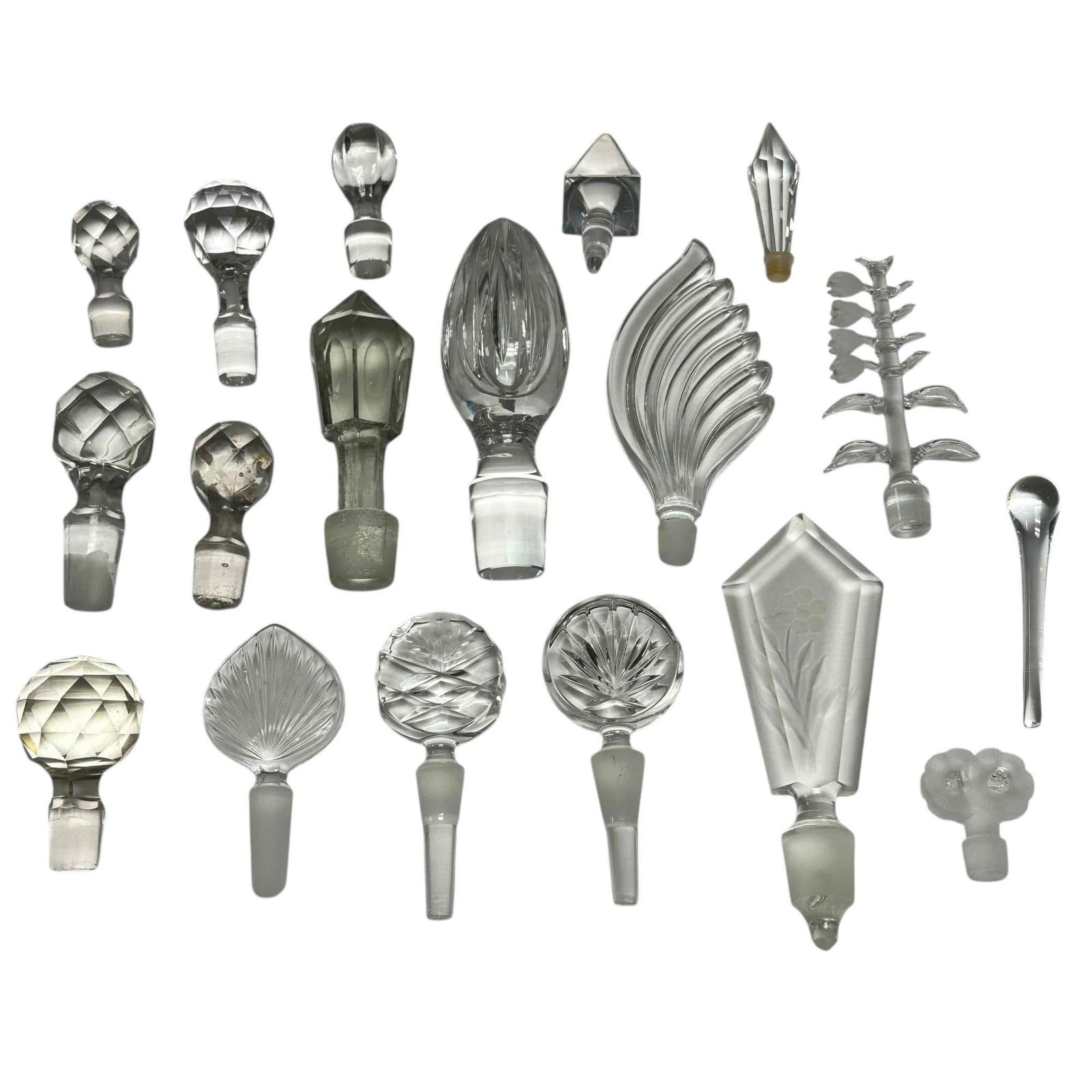 Perfume and Decanter Glass Stopper Collection (18): Collection of eighteen crystal and glass pressed, frost and cut glass perfume bottle and decanter bottle stoppers. Including Lalique, Victorian, floral/foliage and Art Deco style stoppers in various f