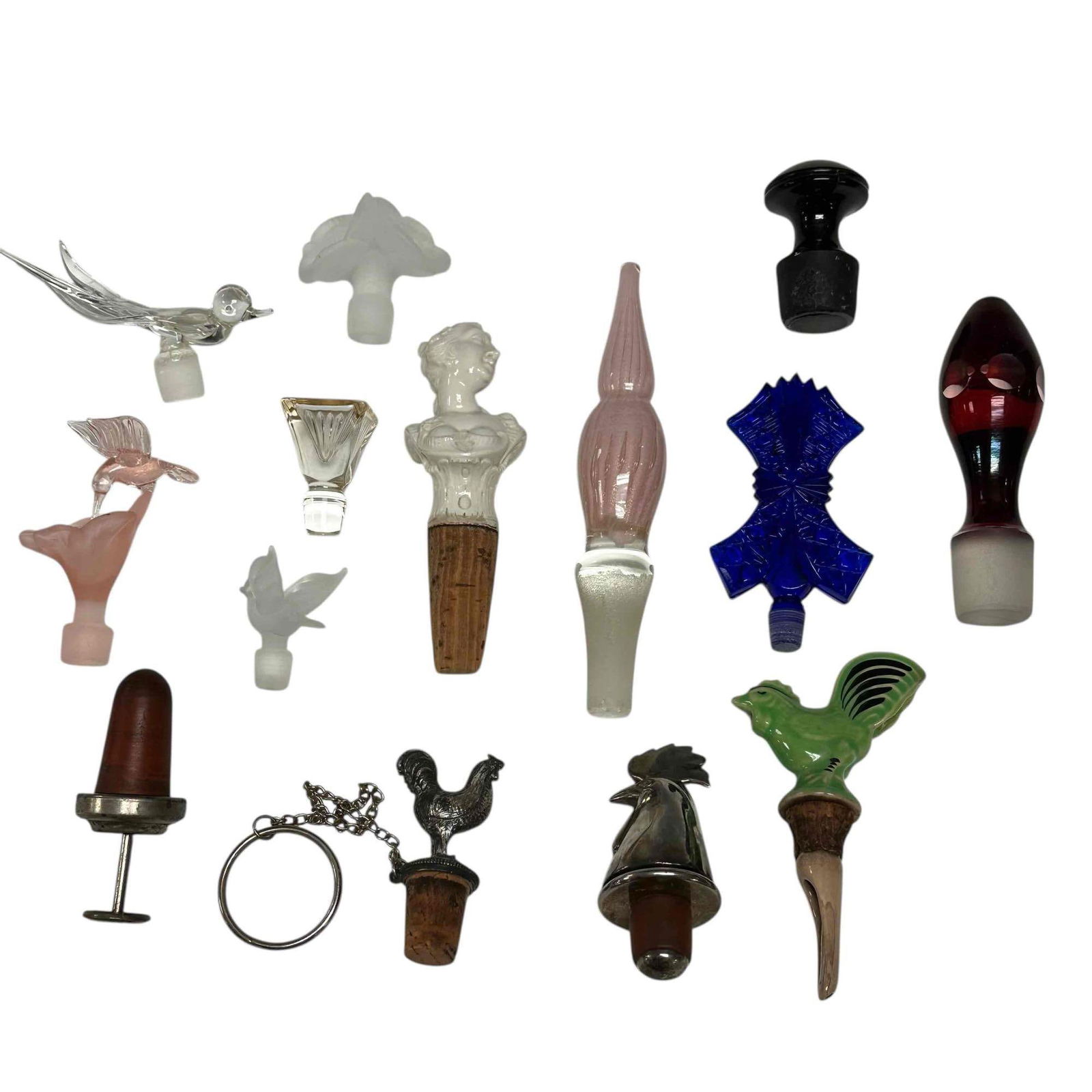 Vintage Art Glass Figural Bottle and Perfume Stoppers (14): Including; Nymphenburg Victorian porcelain woman bust cork stopper, 3 Rooster stoppers, pink hummingbird feeding on flower, Murano art pink gold speckled glass, frosted glass floral, Bohemian ruby gla
