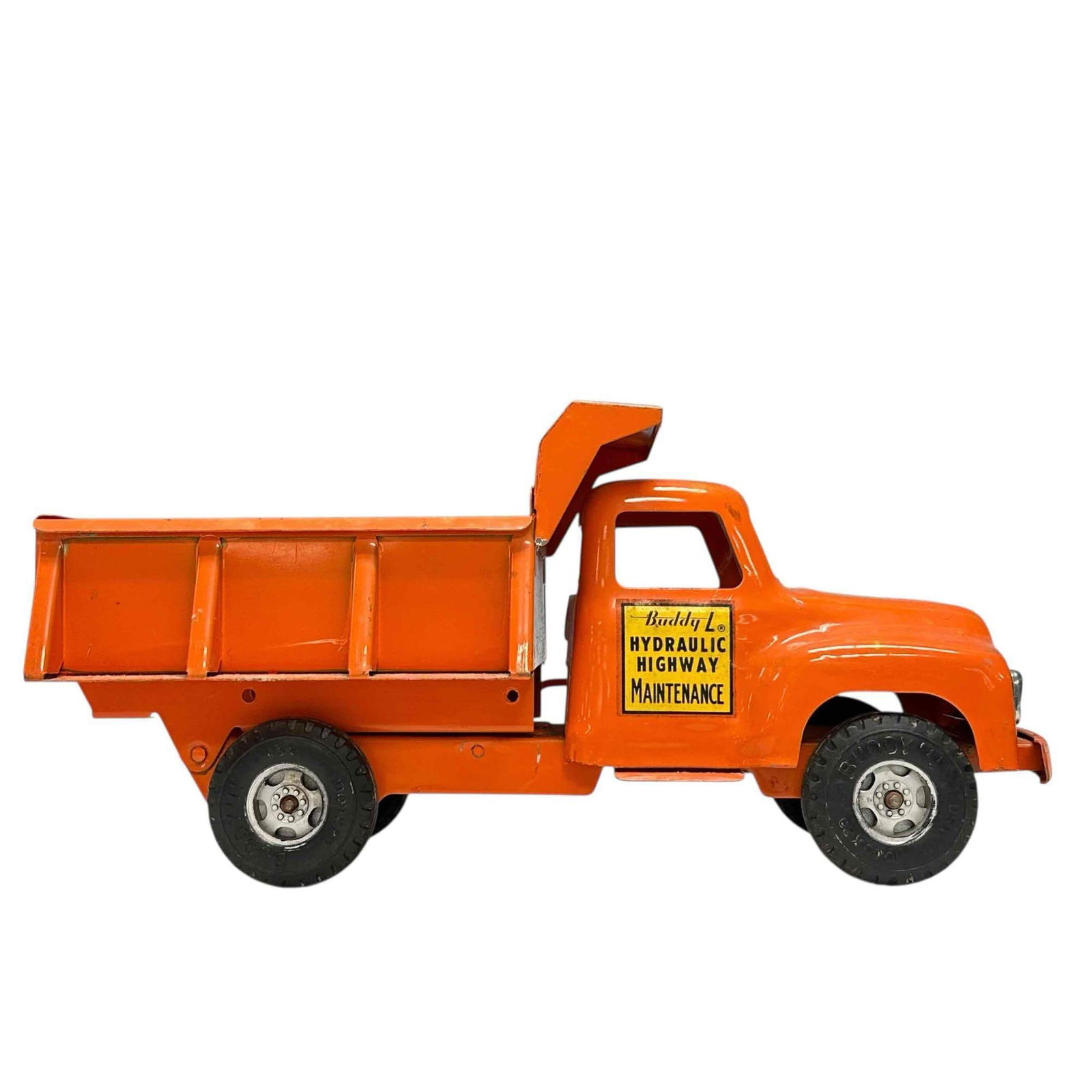 1950's Buddy L Pressed Steel Orange Dump Truck: Buddy L 1950's pressed steel Hydraulic Highway Maintenance orange dump truck with original decals. Measuring approx. 14" long by 6.5" tall. In good age appropriate condition with some spots of yellow
