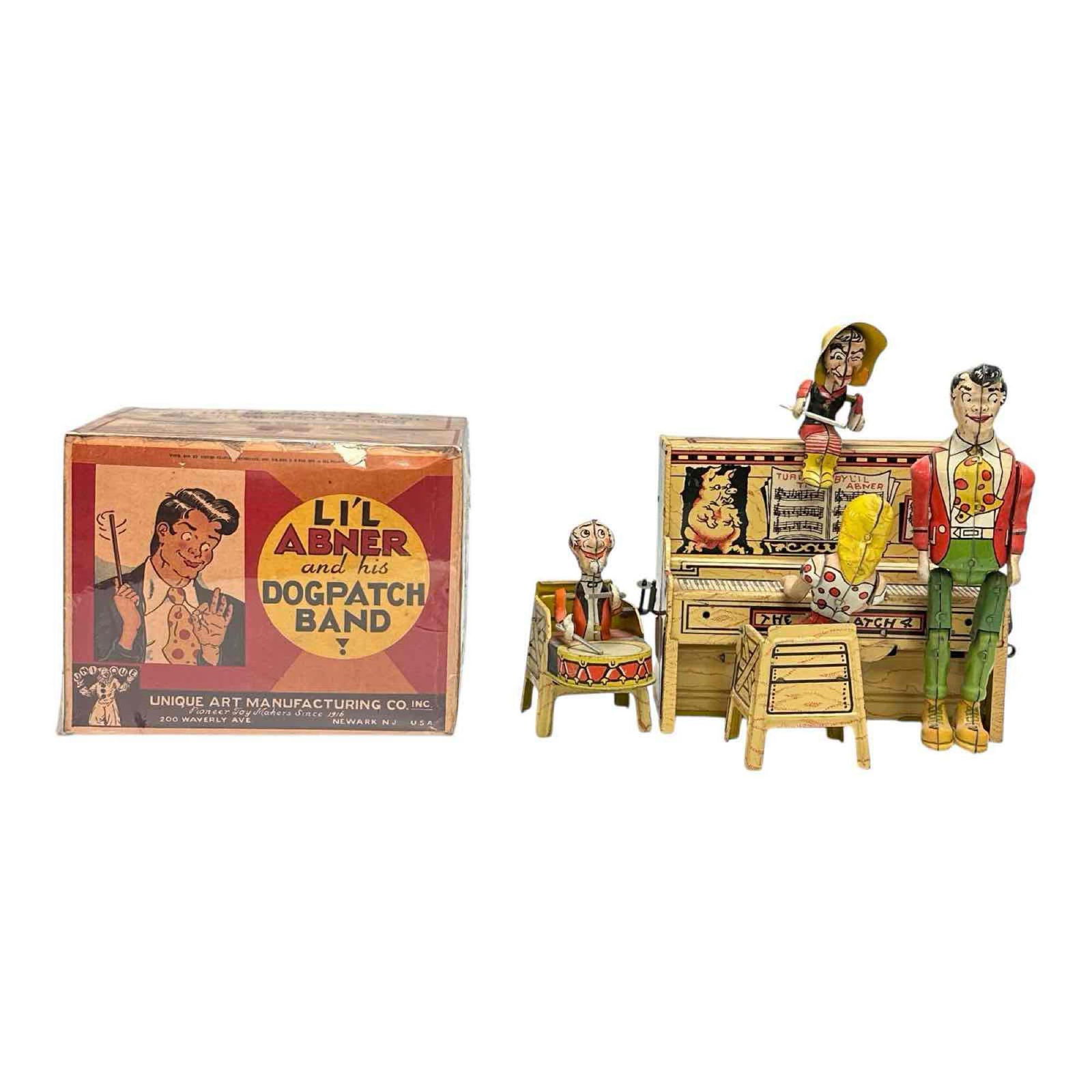 Lil Abner and His Dogpatch Band Unique Art Tin Wind-up in Box: Li'l Abner Dogpatch Band tin lithograph wind-up toy with box. Circa 1945. Manufactured by Unique Art Manufacturing Co. Inc. Measuring approx 10" x 5" x 8-1/4". Box 7-1/2" x 5-1/4" x 5-3/4". CONDITION:
