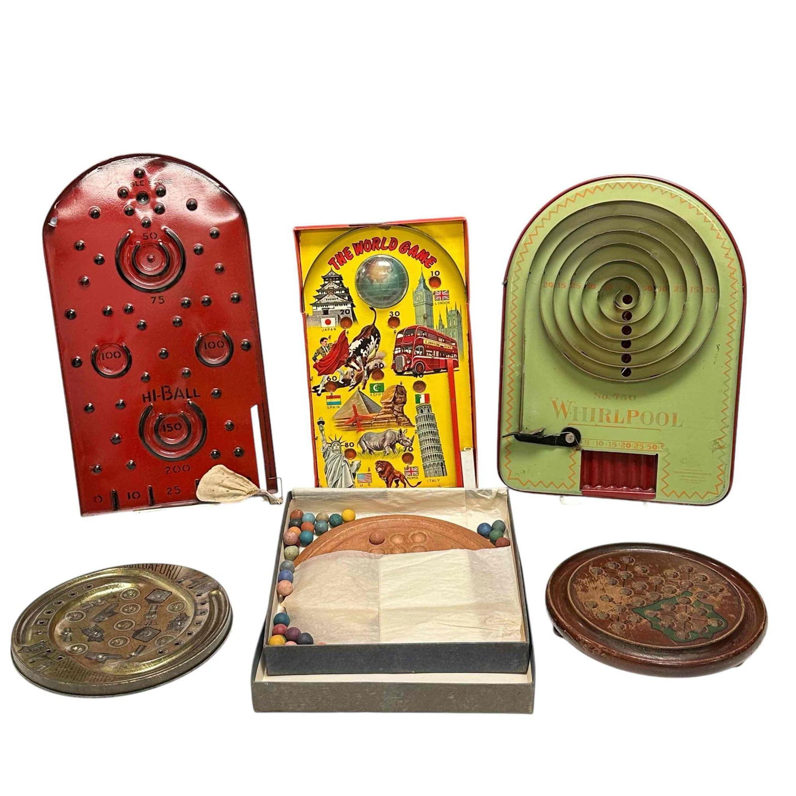 Marble Solitaire and Other Marble Games - Bagatelle and Buildaford: Two marble solitaire games. One is made of wood with heavy scratching from frequent use. The other solitaire is made of clay from The Potter's Wheel which had locations in Massachusetts and Florida at