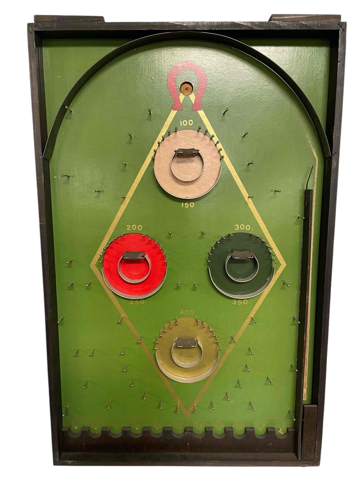 Lindstrom's "Hy Ball" Pin Game Bagatelle: This board of Lindstrom's Hy Ball looks to have all possible board pieces. All pins and cups are attached with some additional flaps over the inner cups. The game board is clean other than the area le