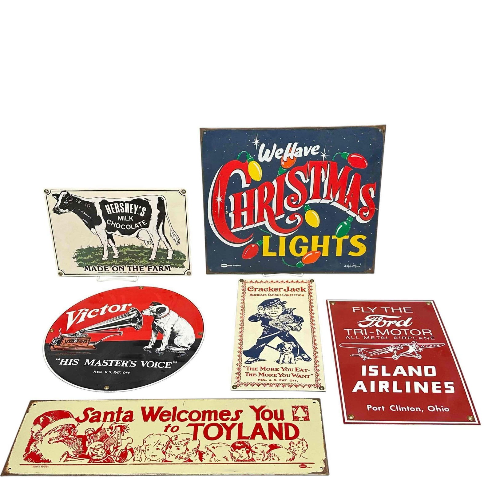 Reproduction Porcelain Sign Group (6): Includes; Mummert Sign Co., Christmas signs, Ford, Cracker Jack, Hershey's and Victor signs. Measuring approx. 7 1/2" to 12" tall. In good condition, see photos.