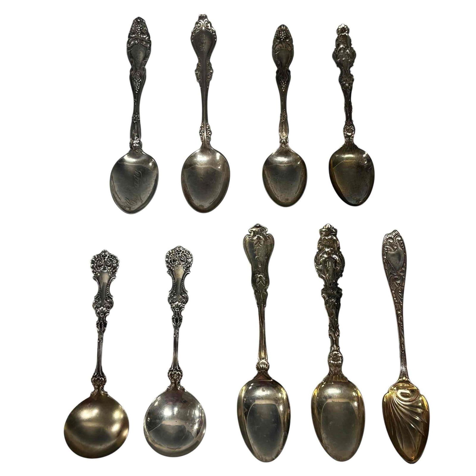 Art Nouveau Foliage Sterling Silver Spoons 204 Grams: Nine ornate floral, grape, foliage gold washed sterling silver teaspoons and soup spoons. Measuring approx. 5.25" to 5.75" long. Total of 204 grams. In good condition, see photos.