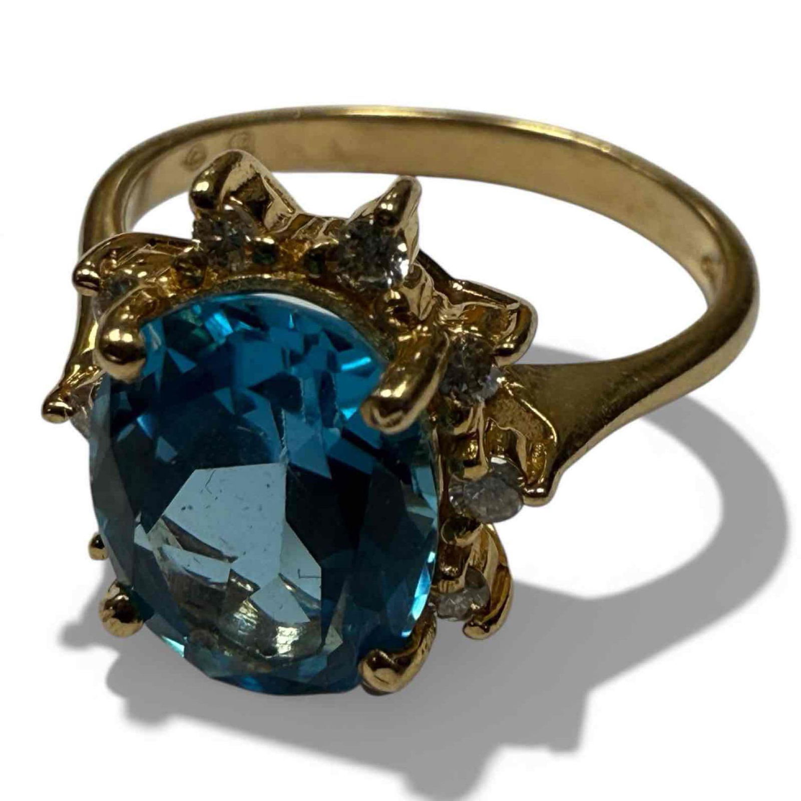 Oval Topaz 14K Yellow Gold Ladies Ring: 14k yellow ring with oval London Blue Topaz center stone in a diamond halo setting. Size 6.25. weighting 4 grams. In good condition, see photos.