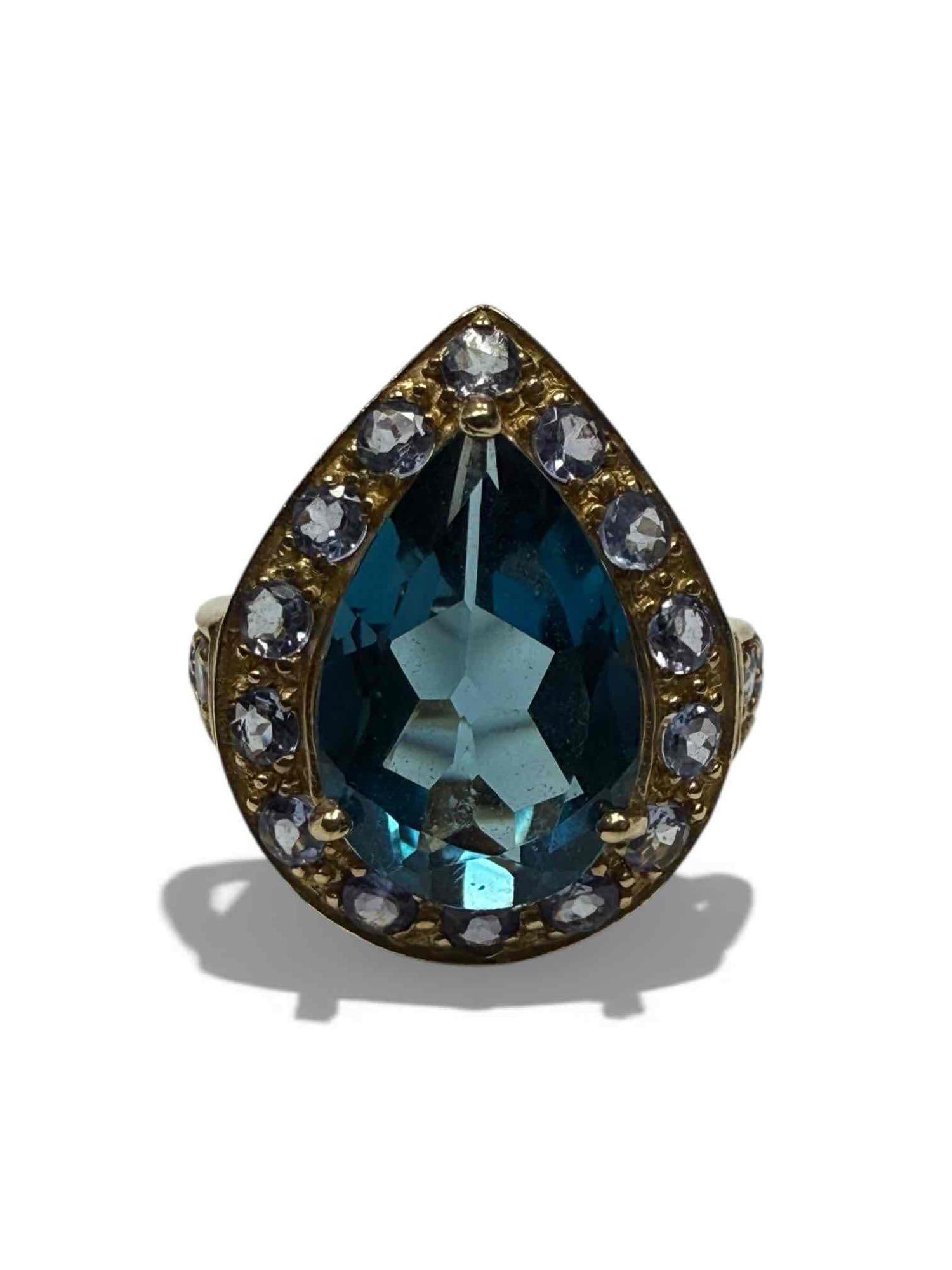 Pear Cut Blue Topaz 10K Yellow Gold Cocktail Ring: 10k yellow gold pear shaped blue topaz ring with accent halo stones. Size 6, 4.7 grams. In good condition, see photos.