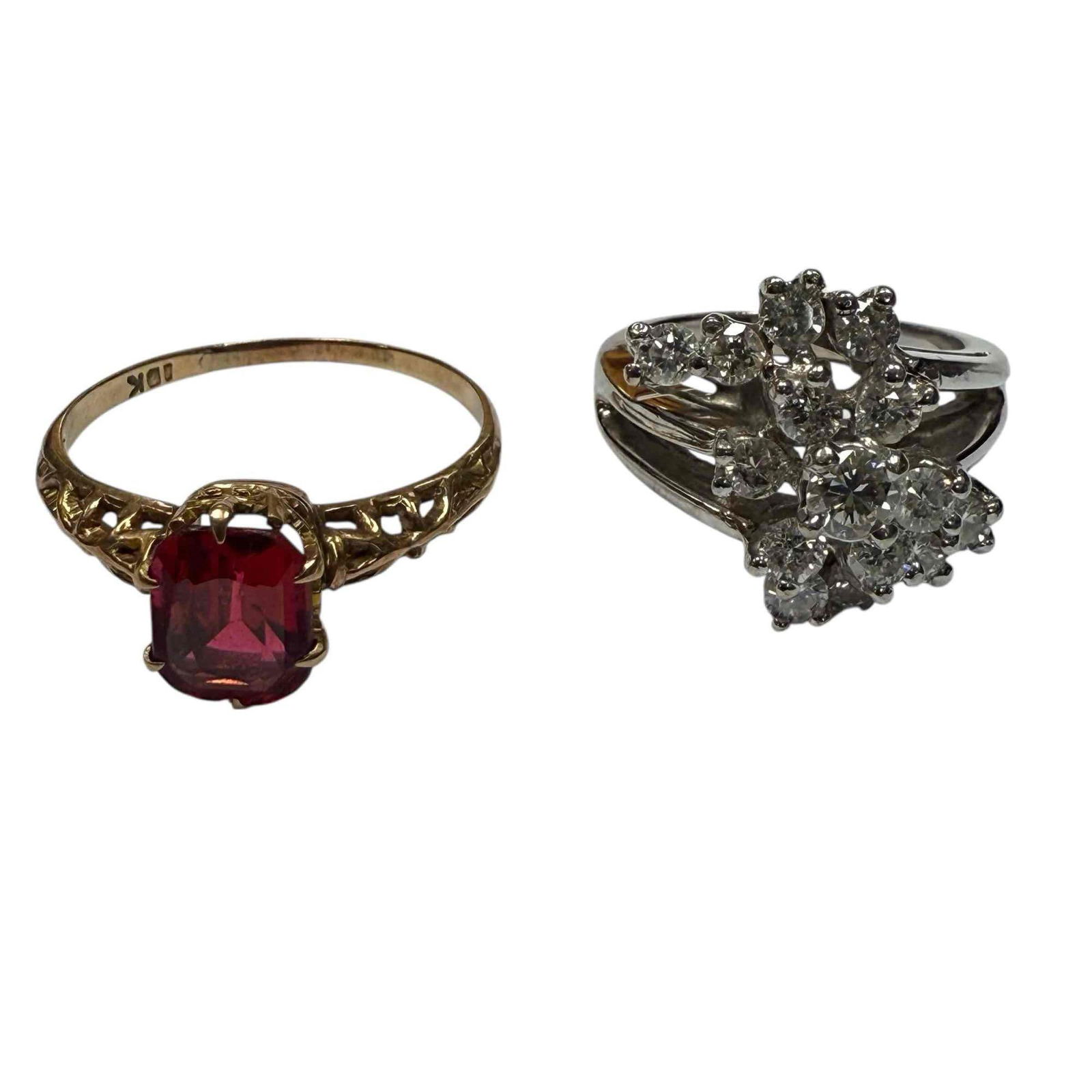 Ruby & Diamond 10K White and Yellow Gold (2): Emerald cut ruby set in filigree 10k yellow gold band size 9.25 accompanied by 10k white gold diamond cluster ring with 15 diamonds size 5. Total combined weight 8.7 grams. In good condition, see phot