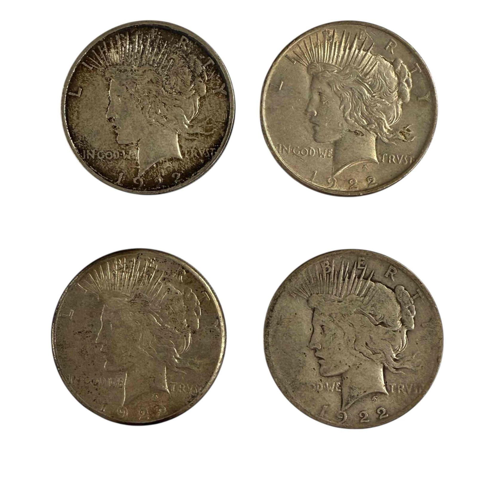 1922 Peace Silver Dollars (4): Four 1922 Peace silver dollars. See photos for condition.