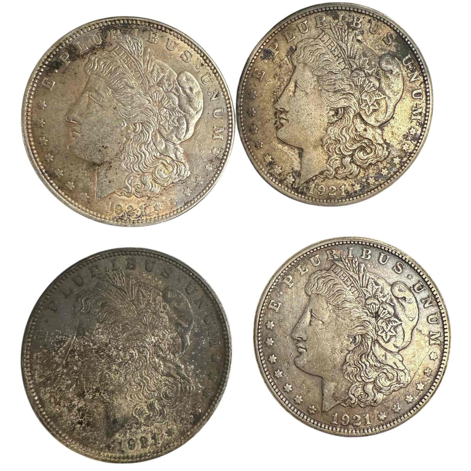 1921 Morgan Silver Dollars (4): Four 1921 Morgan silver dollars including two 1921 S and one 1921 D. See photos for condition.