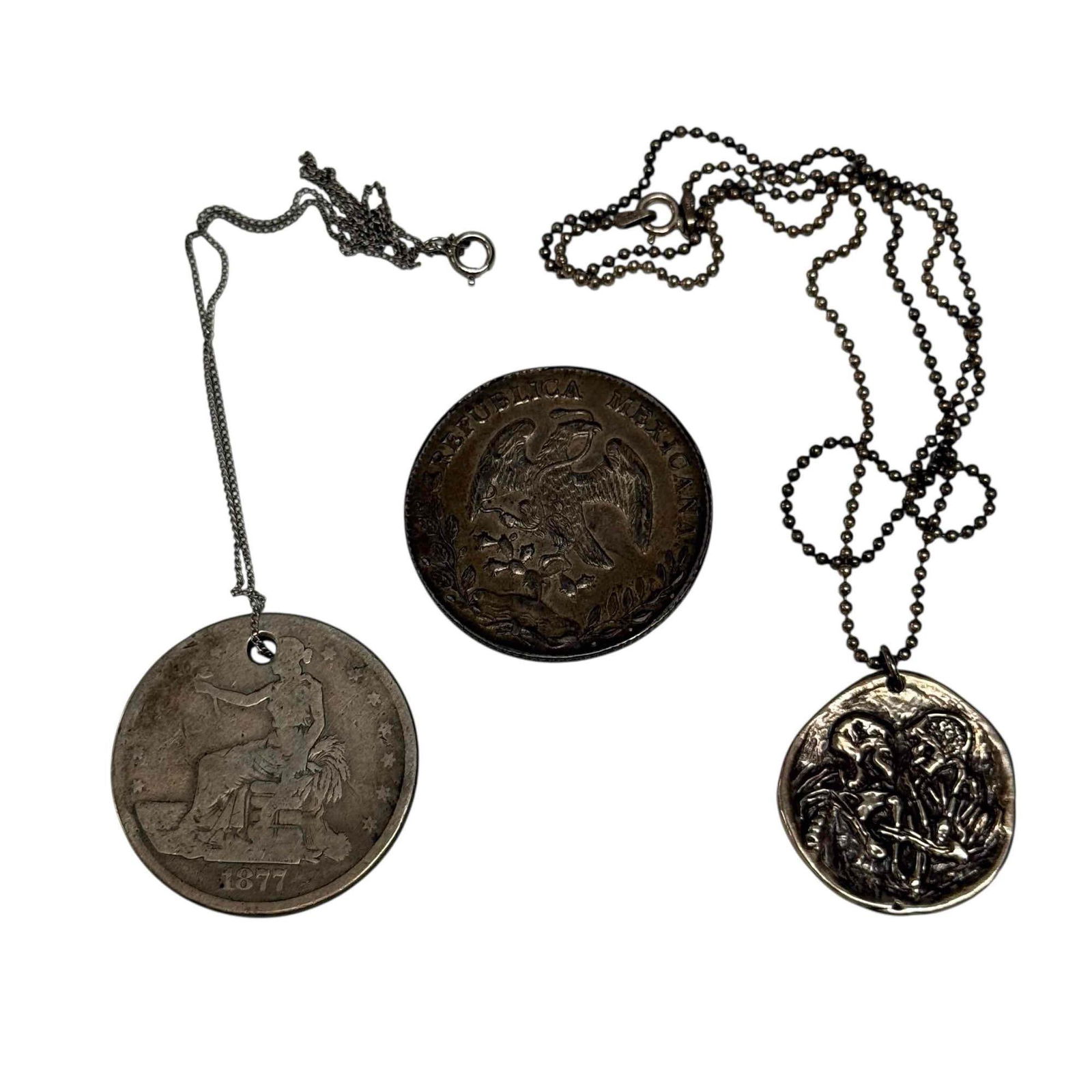 19th Century Silver Trade Coins with 1877 U.S. Trade Dollar & Sterling Pendant: 1877 U.S. Seated Liberty trade coin converted to necklace pendant, 1896 Mexican 8 Reales (Cap and Rays) silver trade coin in nice condition and sterling silver pendant depicting skeleton couple embrac