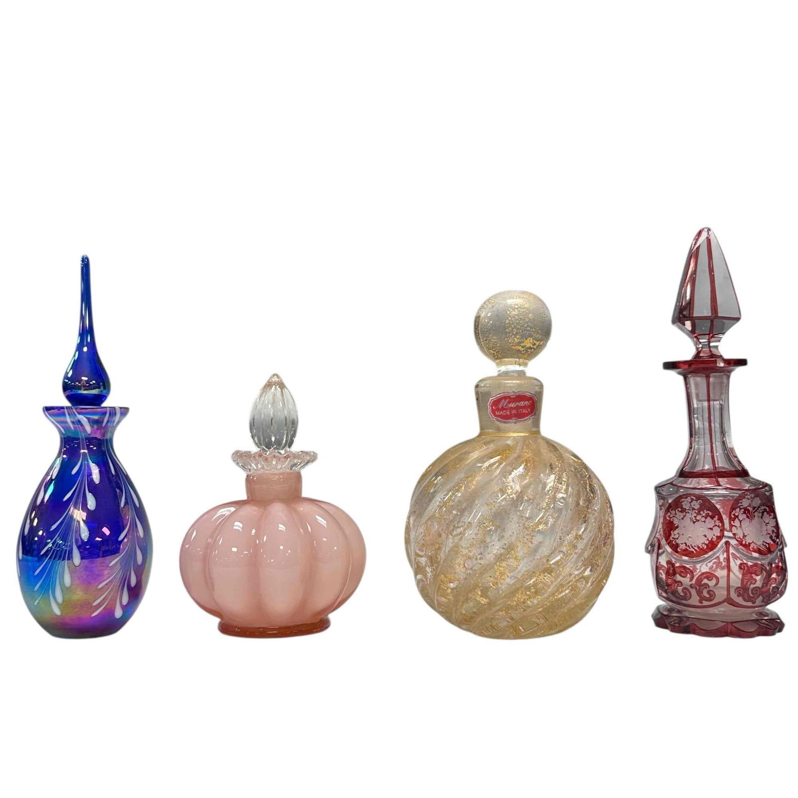 Art Glass Perfume Bottle Decanters (4): Includes; Murano gold fleck swirled body 5.75" tall, bohemian ruby cut to clear with etched floral motif 7.25" tall with rim chip and stopper point damage, blue/purple iridescent with white pearl pull