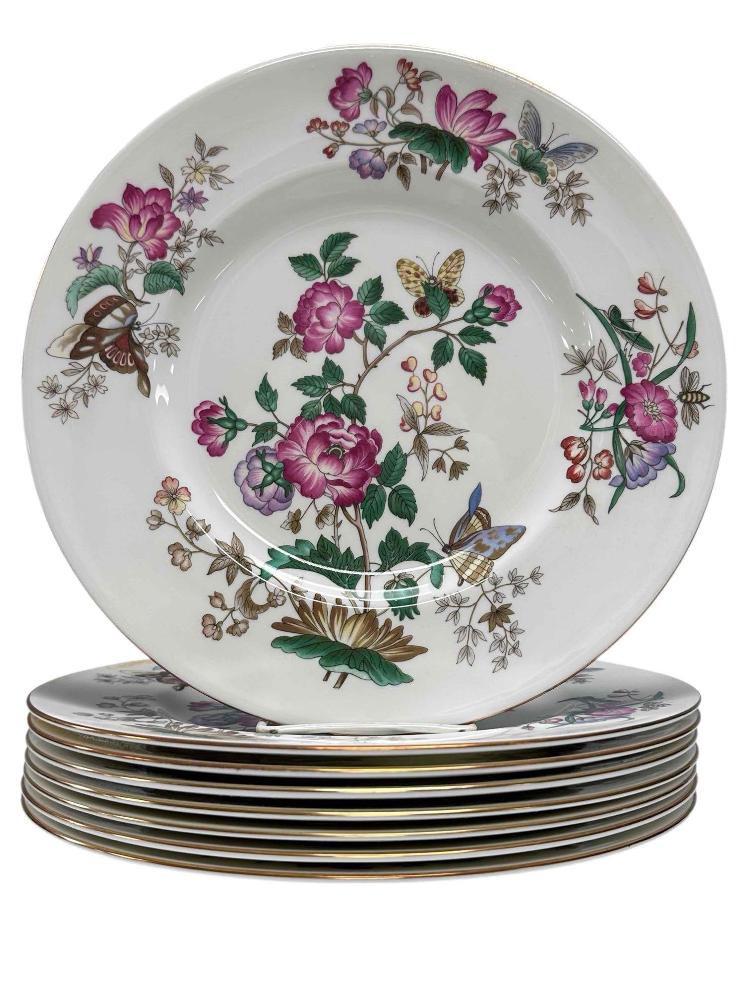 Eight Wedgewood "Charnwood" Dinner Plates: Set of eight Wedgewood bone China dinner plates in the Charnwood pattern. Charnwood pattern is a delicate floral and butterfly design with a gold-trimmed rim on the plate. Measure approx 10 3/4". Coup
