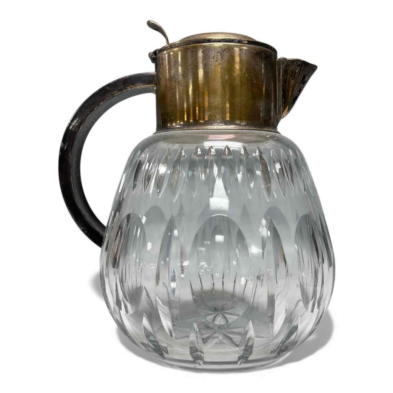 German Cut Crystal Hinged Lidded Pitcher/Decanter: Early to mid 20th century thick cut crystal decanter with hinged silver plate lid and handle. Cut facets and medallion bulbous body with starburst base. Stamped on neck Silverplated Germany U.S. Zone.