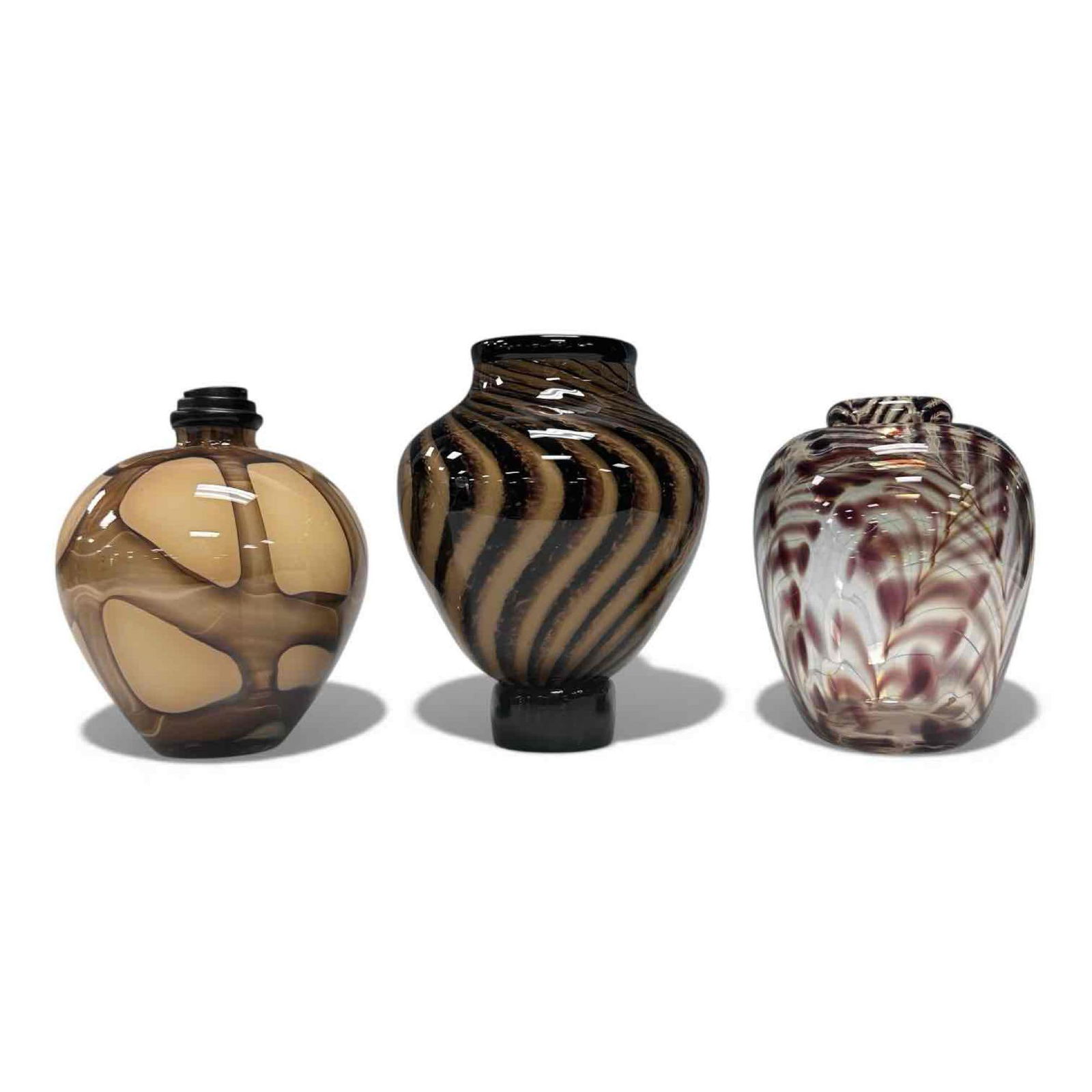 Art Glass Vessels Vases Artist Signed (3): Hand blown clear brown feathered vase by James Clark 1983 5.25" tall, hand blown swirled tortoise shell pattern signed possibly McQuade 6.25" tall and brown patch swirl possibly oil lamp 5.75" tall. I